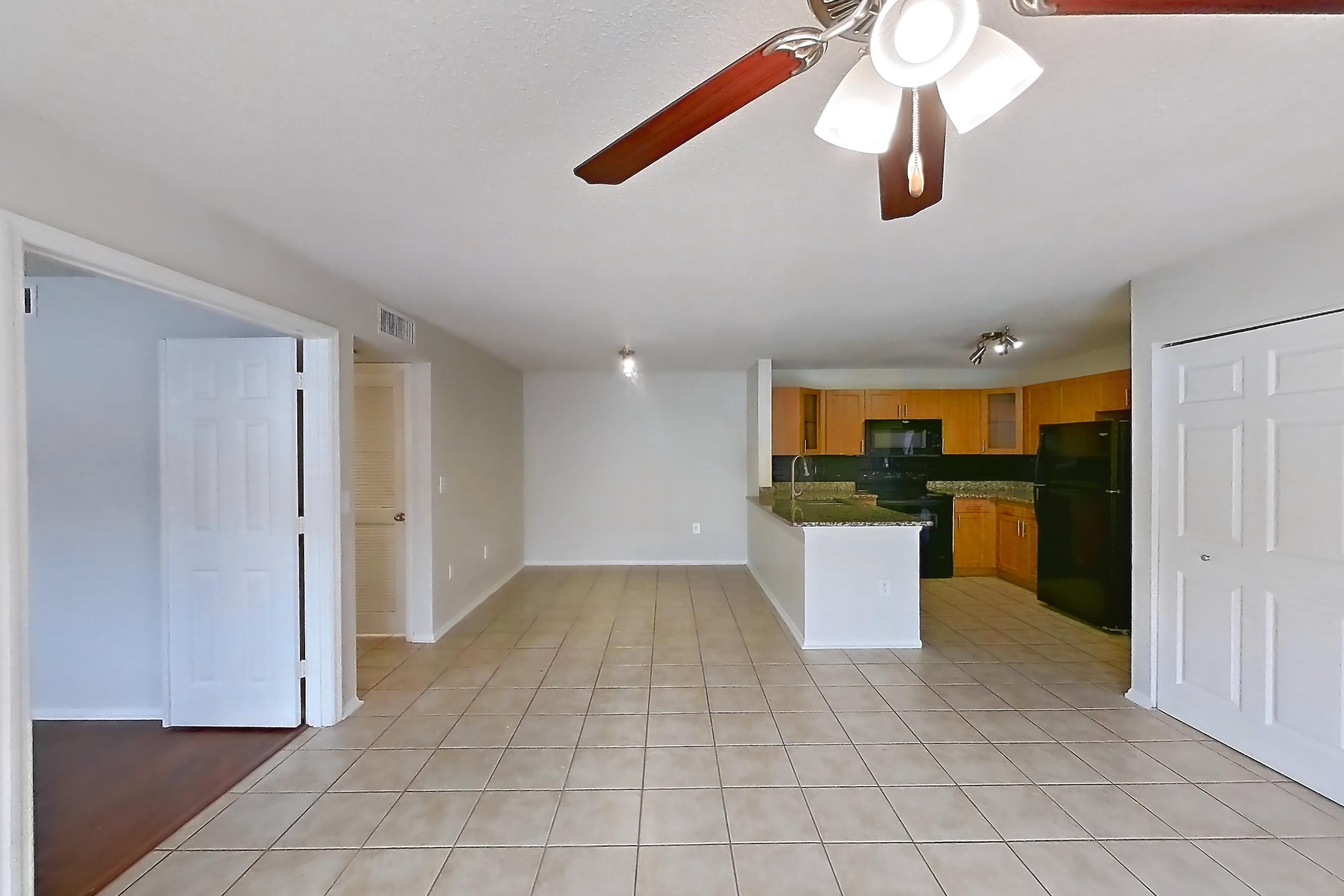 Living space with black appliances, electric range, light tile flooring, oven/range, and refrigerator, Apartment 465442 at Cortland Bayport