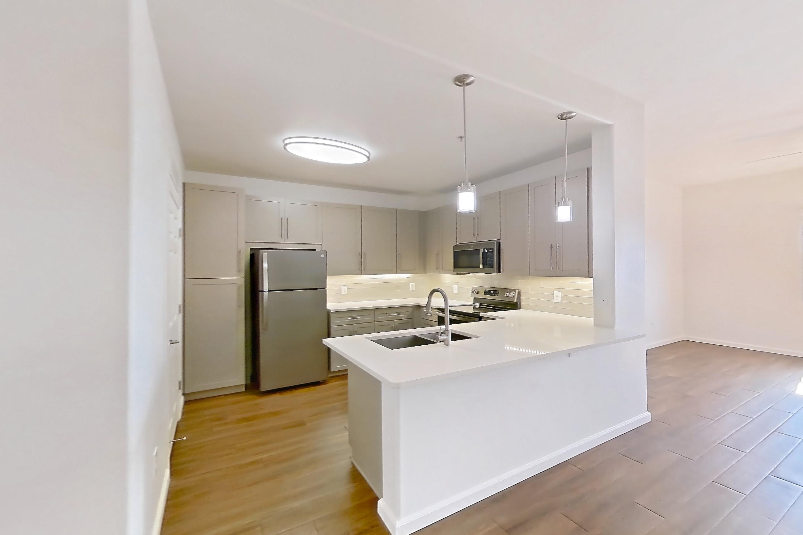 Dining room with black appliances, dark wood-finish flooring, light countertops, oven/range, refrigerator, and stainless steel appliances, Apartment 3113 at Cortland South Mountain