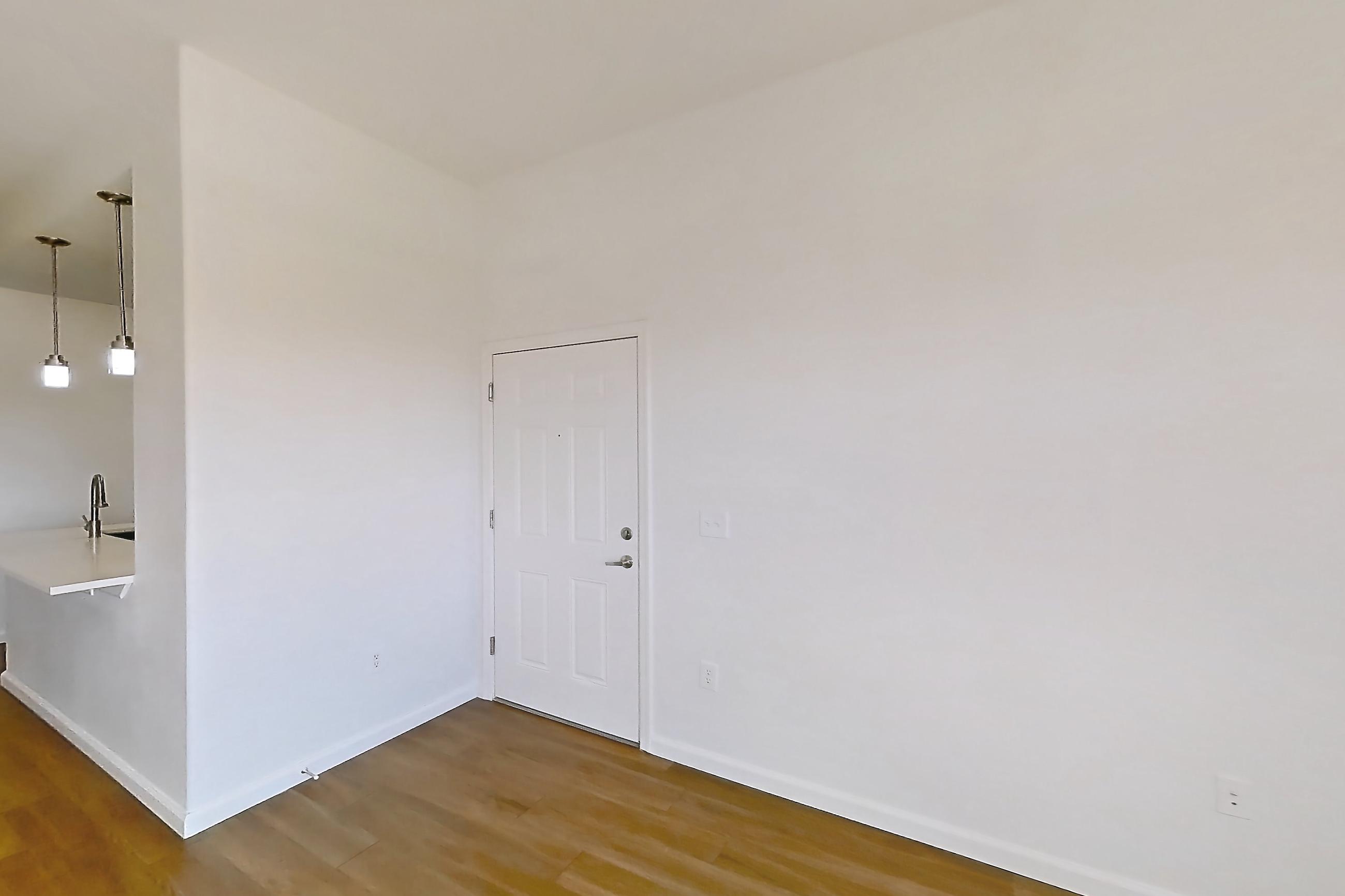 Living room with dark wood-finish flooring, Apartment 3113 at Cortland South Mountain