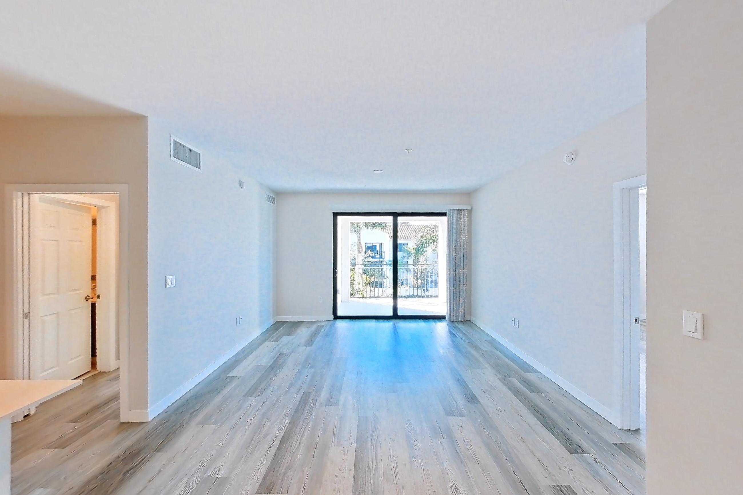 Living space with electric range, light countertops, light stone countertops, light wood-finish flooring, oven/range, and stainless steel appliances, Apartment 02-303 at Cortland South Kendall
