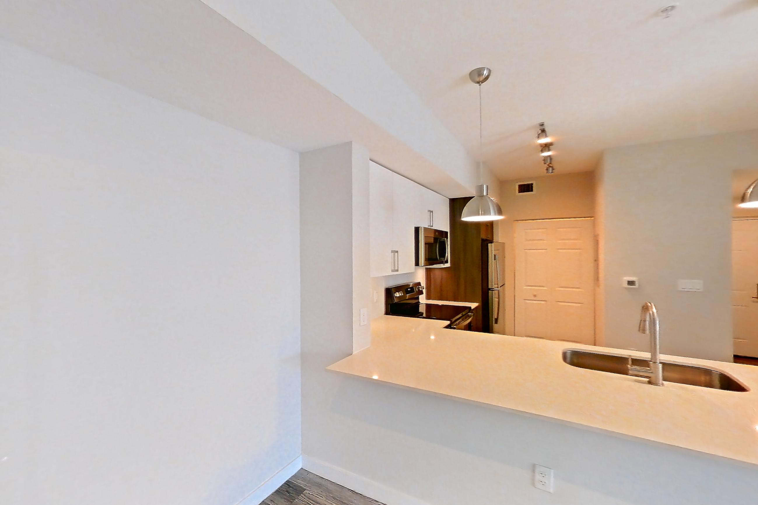 Living space with electric range, light countertops, light stone countertops, light wood-finish flooring, oven/range, and stainless steel appliances, Apartment 02-303 at Cortland South Kendall