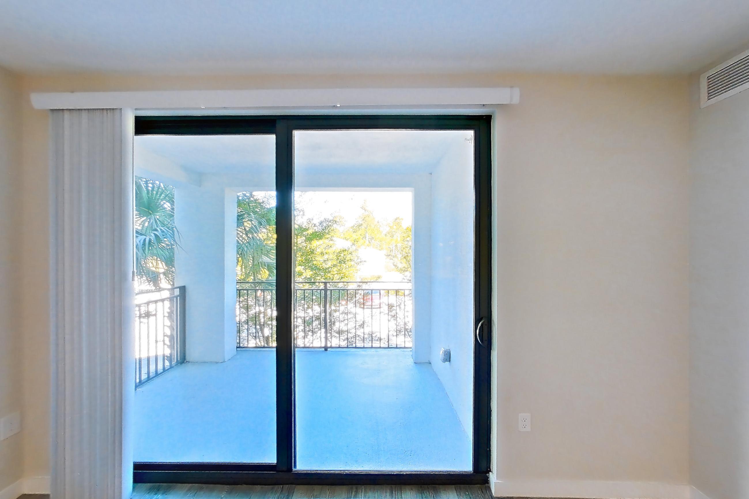 Living room with dark wood-finish flooring, Apartment 05-204 at Cortland South Kendall