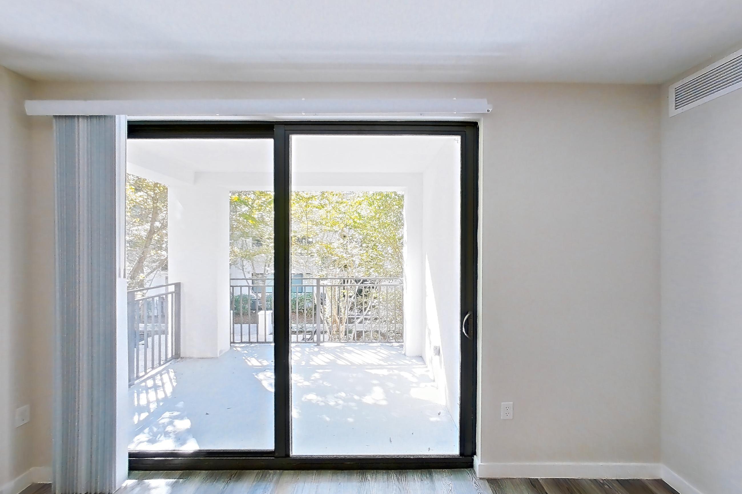 Living room with dark wood-finish flooring, Apartment 05-205 at Cortland South Kendall