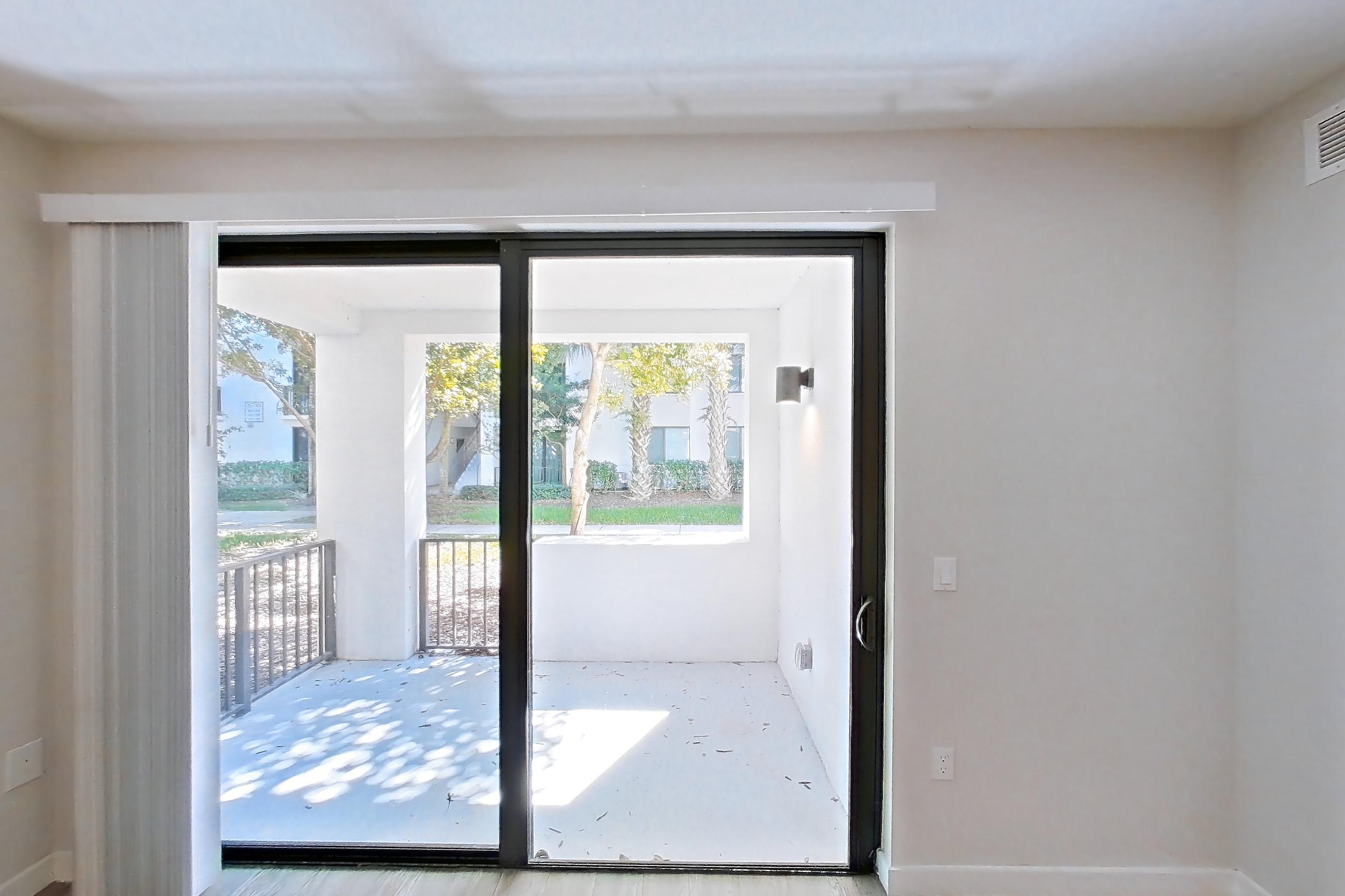 Living room with light wood-finish flooring, Apartment 10-101 at Cortland South Kendall