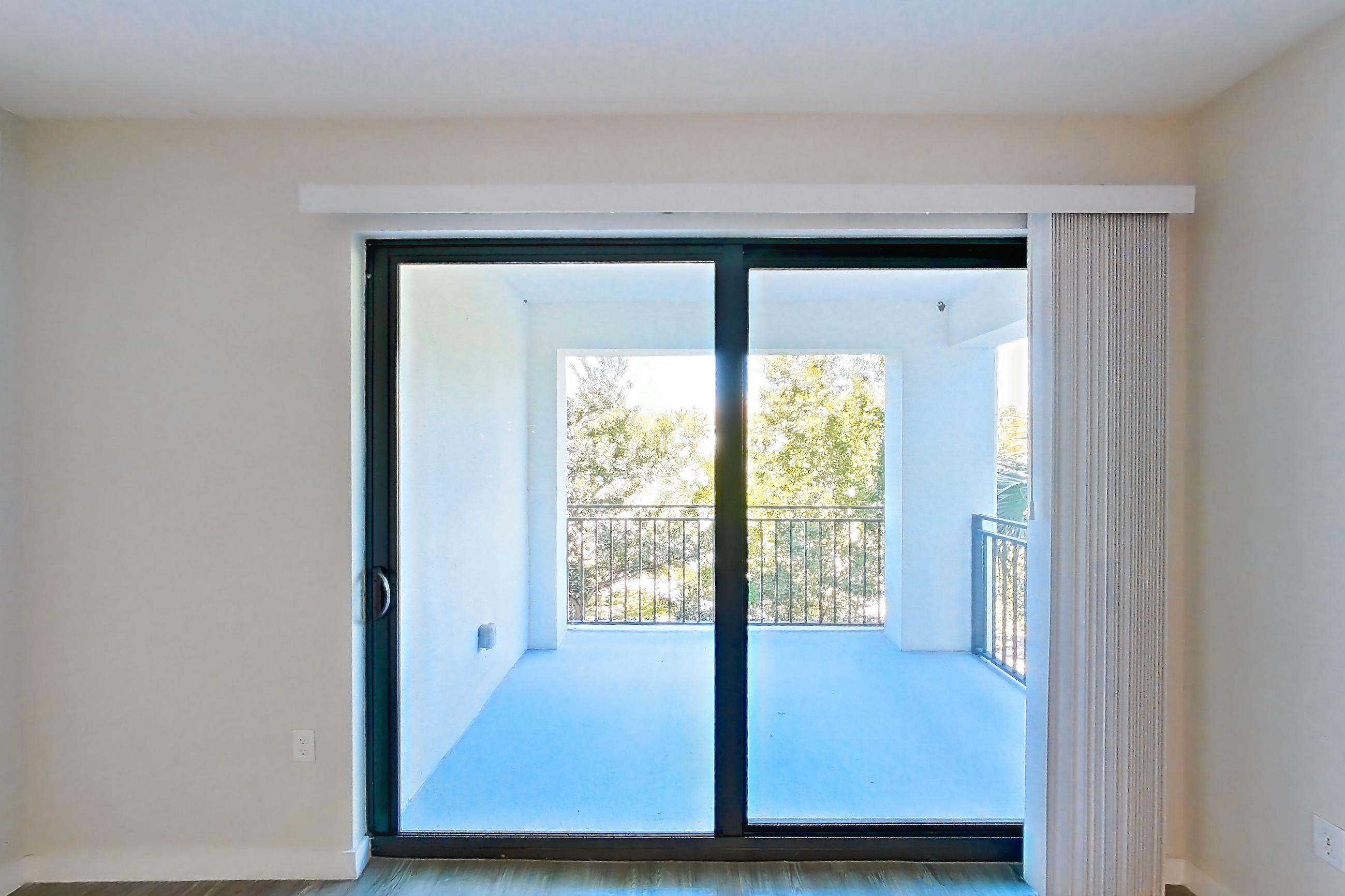 Living room with dark wood-finish flooring, Apartment 11-307 at Cortland South Kendall