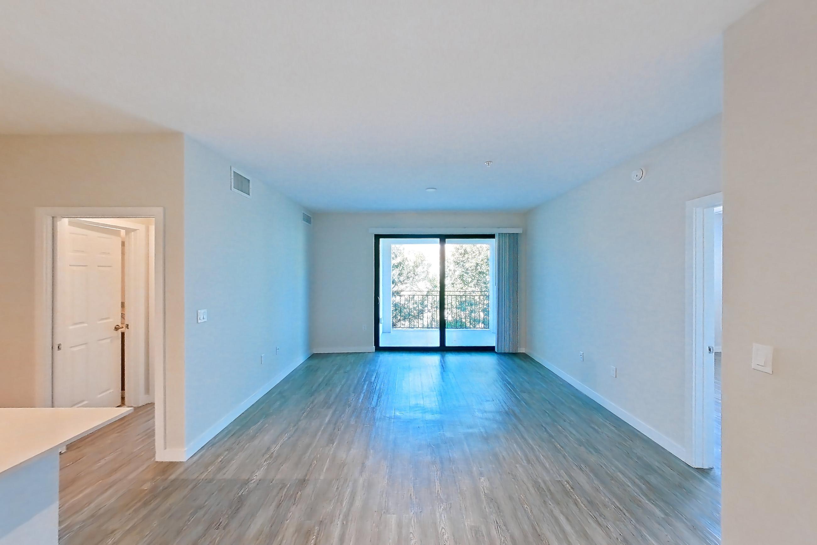 Living space with electric range, light countertops, light wood-finish flooring, oven/range, refrigerator, stainless steel appliances, and white appliances, Apartment 11-307 at Cortland South Kendall
