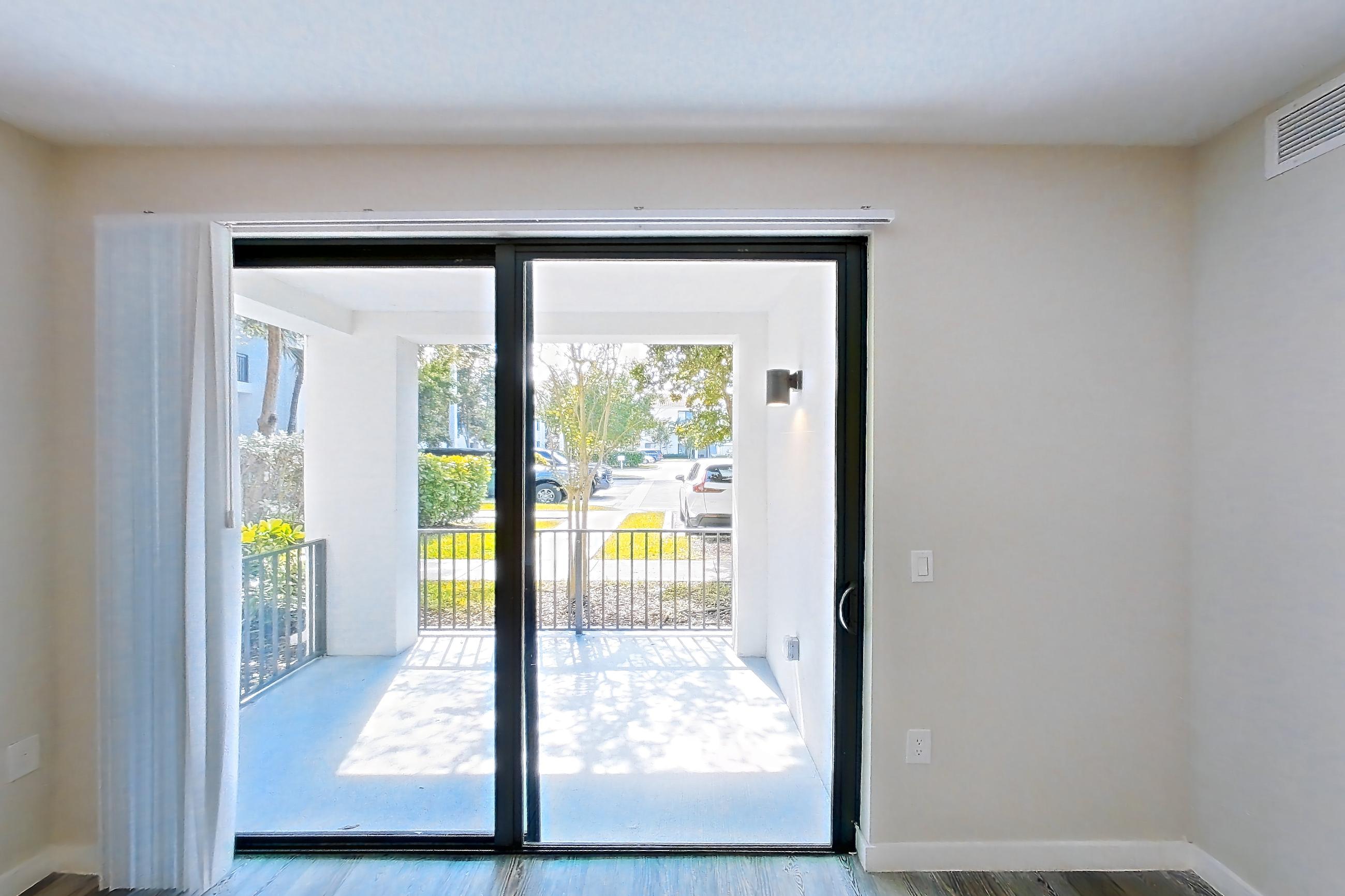 Living room with light wood-finish flooring, Apartment 15-108 at Cortland South Kendall
