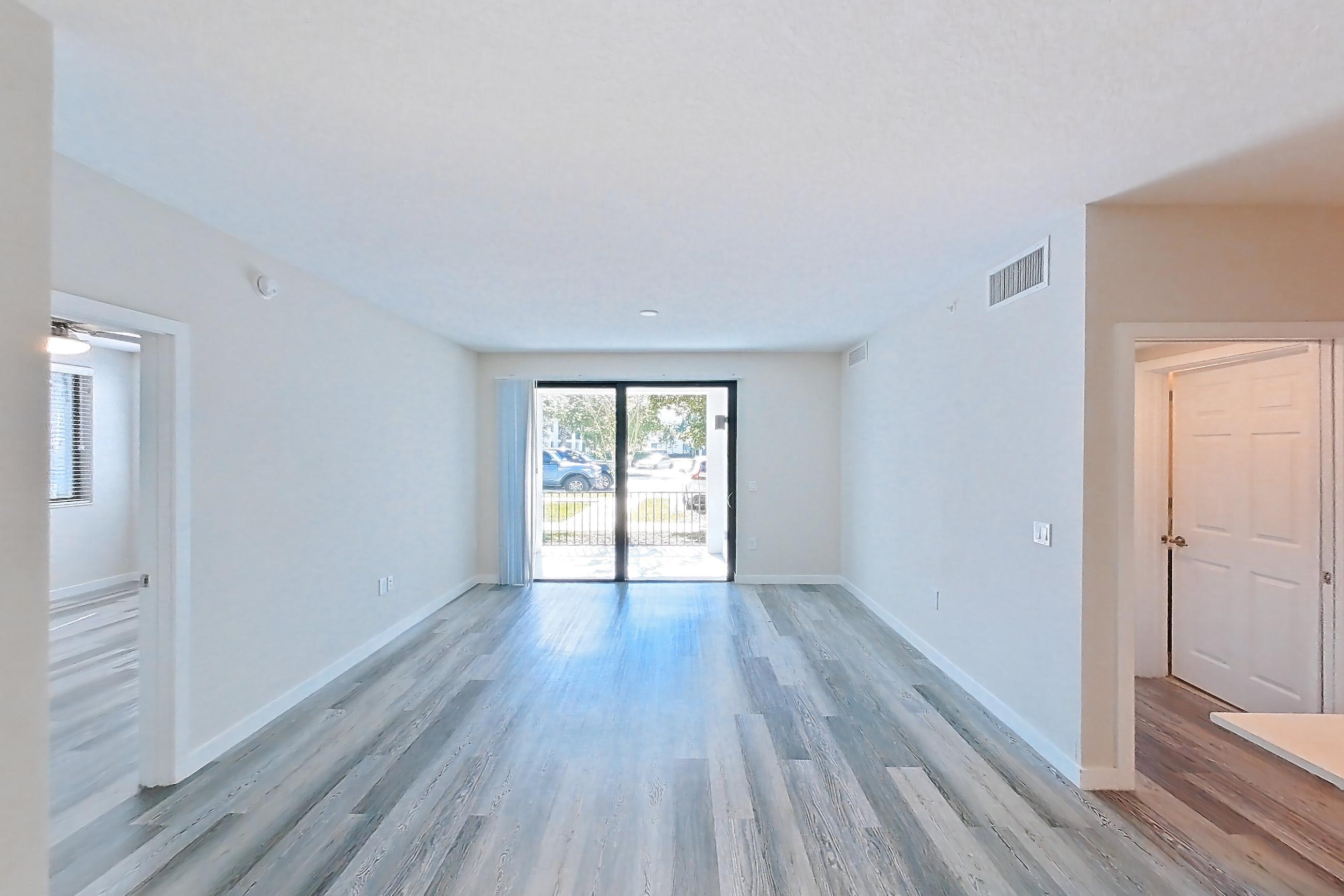 Living space with electric range, light countertops, light stone countertops, light wood-finish flooring, oven/range, refrigerator, and stainless steel appliances, Apartment 15-108 at Cortland South Kendall