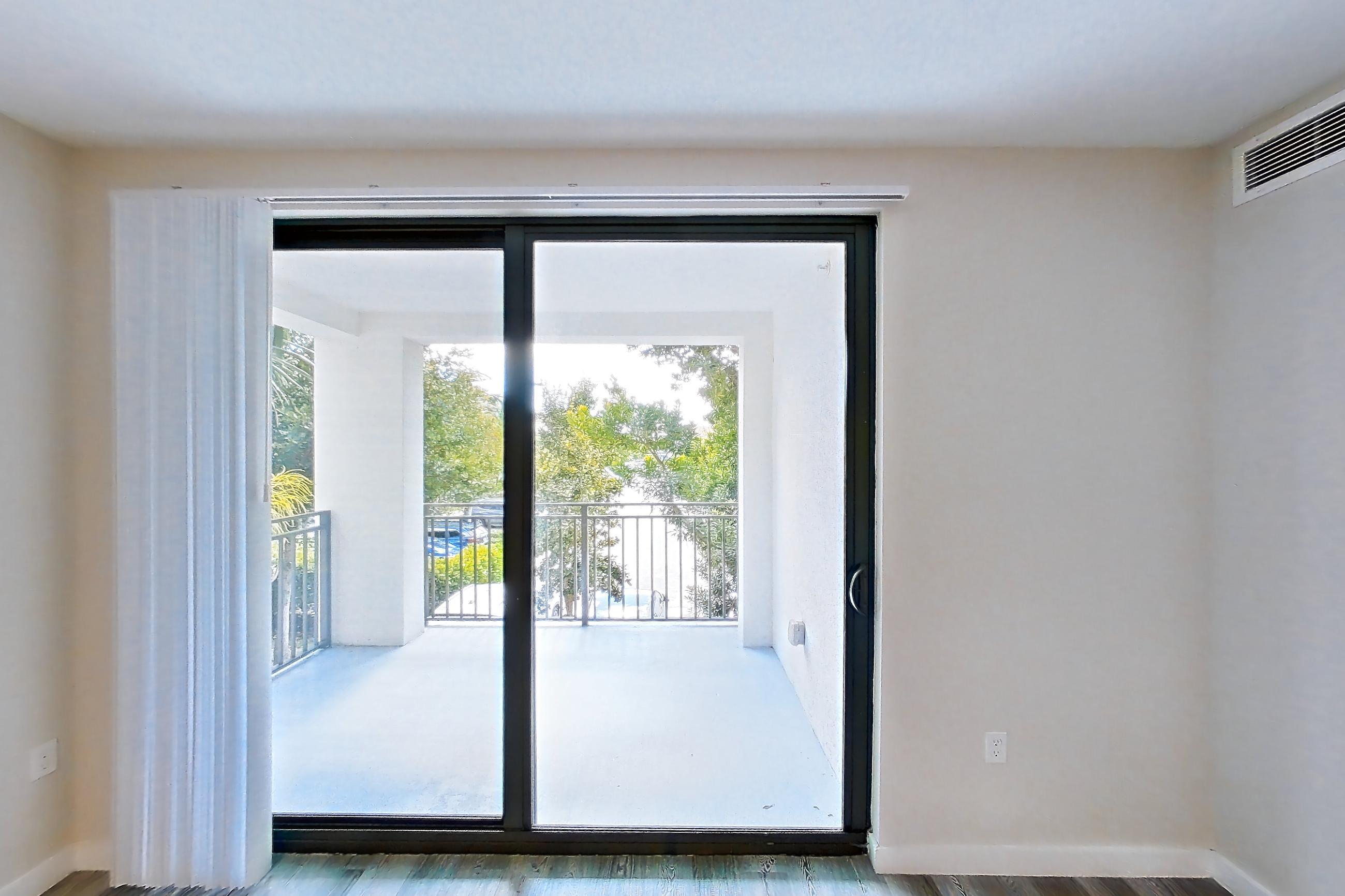 Living room with dark wood-finish flooring, Apartment 17-205 at Cortland South Kendall