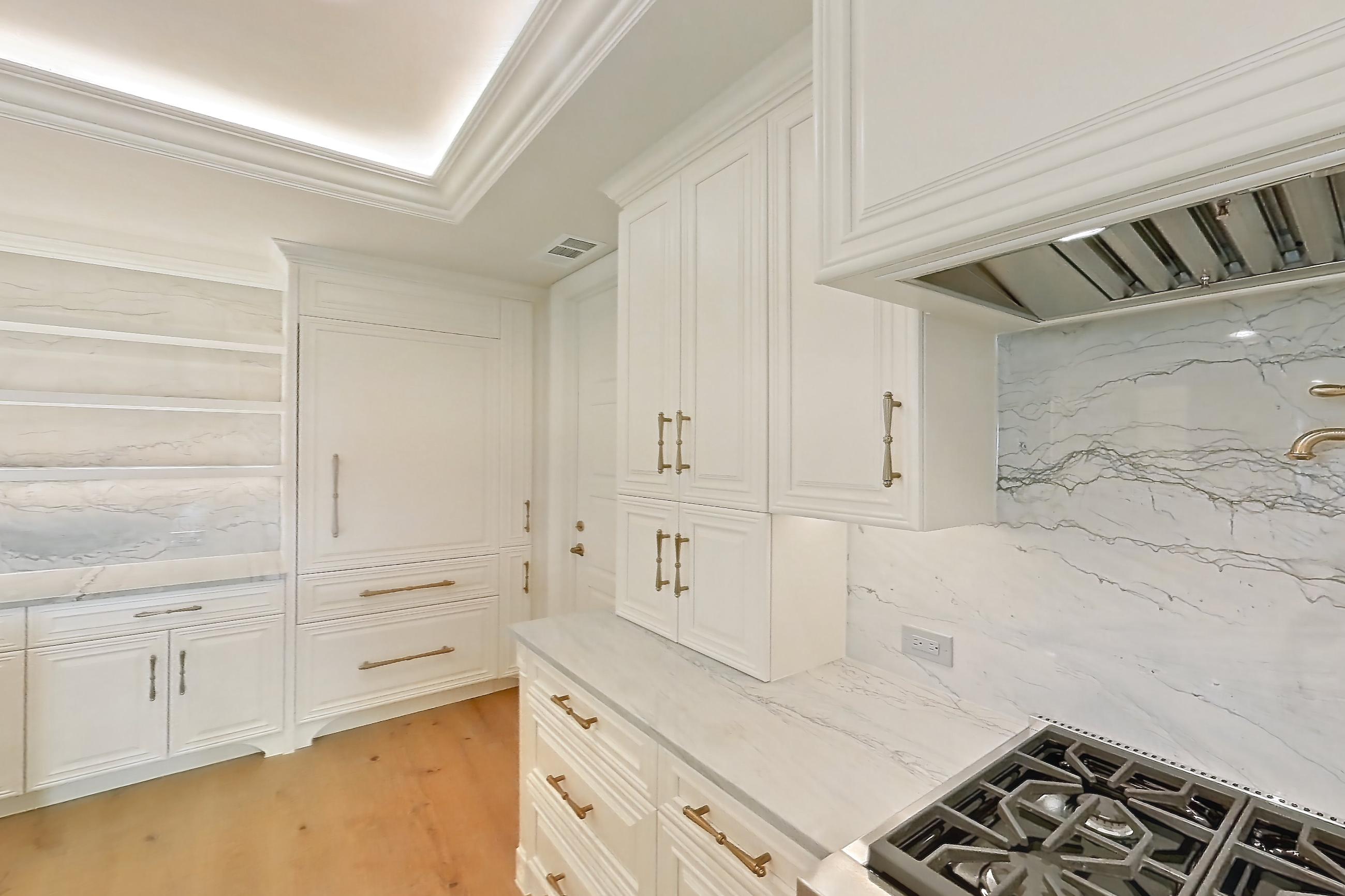 Kitchen with cooktop, double oven, gas cooktop, light stone countertops, light wood-finish flooring, stainless steel appliances, and wood-finish flooring, Apartment 1807 at The Langley
