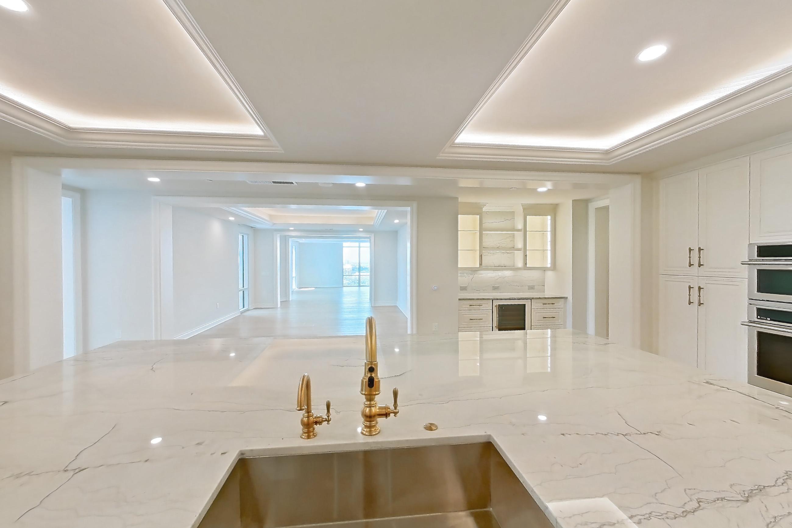 Kitchen with cooktop, double oven, gas cooktop, light stone countertops, light wood-finish flooring, stainless steel appliances, and wood-finish flooring, Apartment 1807 at The Langley