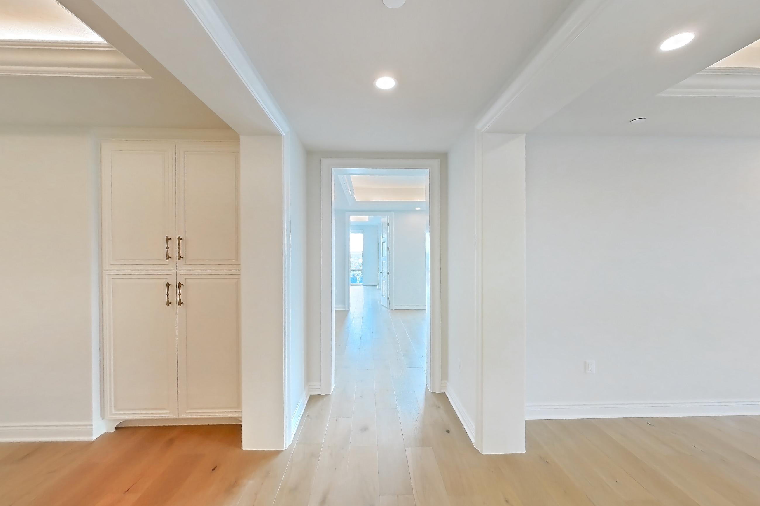 Living space with gas range, kitchen island, light stone countertops, light wood-finish flooring, oven/range, stainless steel appliances, and wood-finish flooring, Apartment 1807 at The Langley