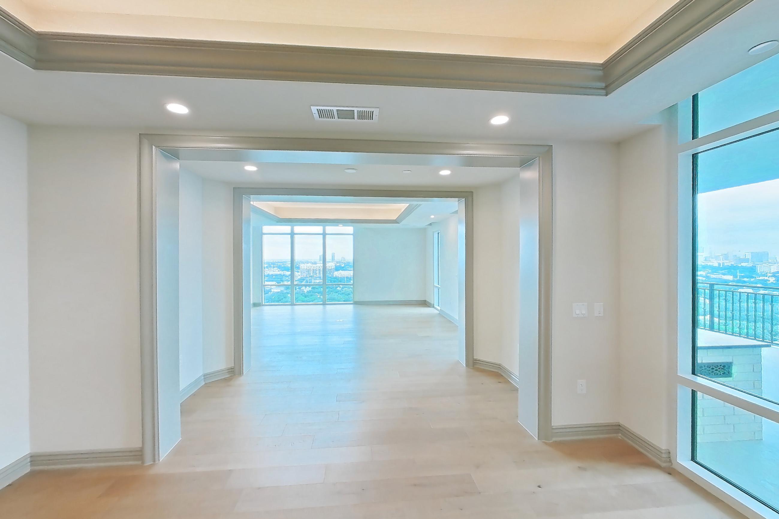 Living space 3 with light wood-finish flooring, Apartment 1902 at The Langley