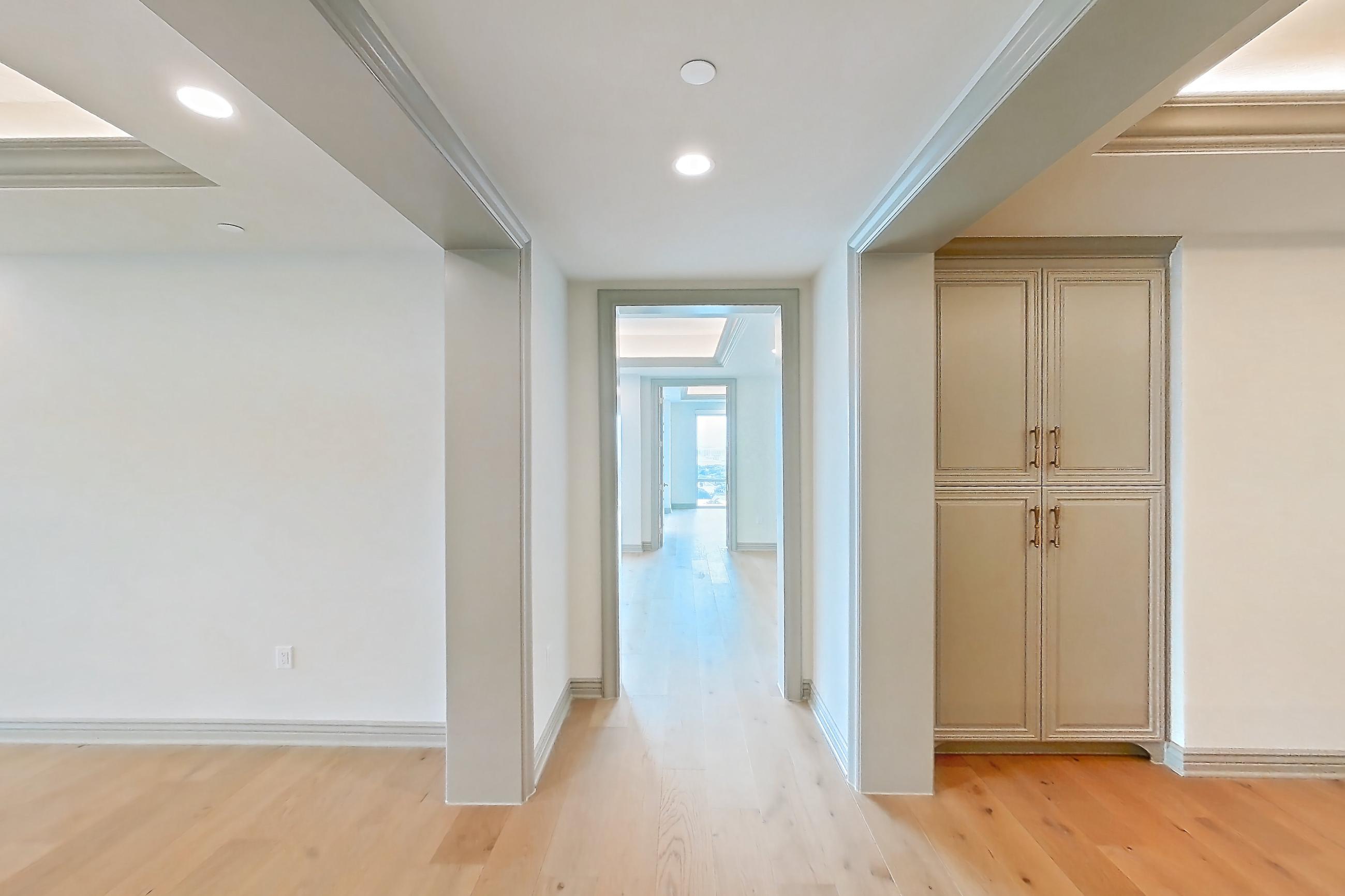 Living space with gas range, kitchen island, light stone countertops, light wood-finish flooring, oven/range, stainless steel appliances, and wood-finish flooring, Apartment 1902 at The Langley