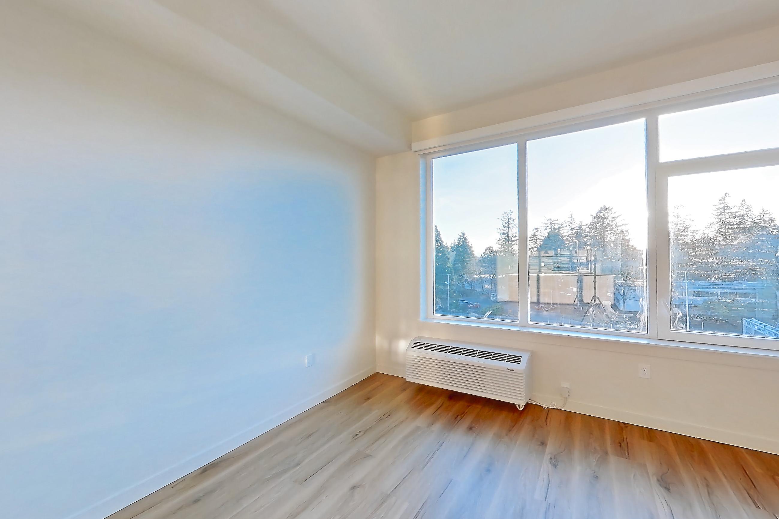 Living room with air conditioning and light wood-finish flooring, Apartment 633 at Montage Tigard