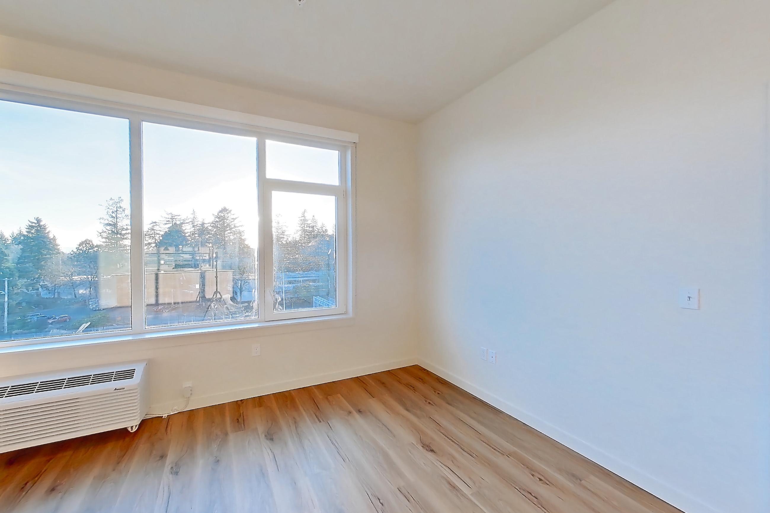 Living room with air conditioning and light wood-finish flooring, Apartment 633 at Montage Tigard