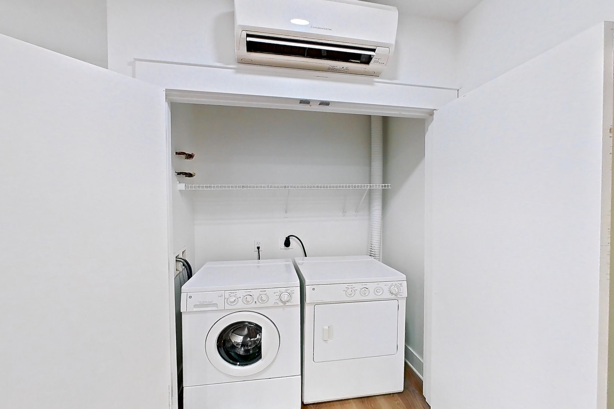 Living space with baseboard heating, in-unit laundry, light wood-finish flooring, and mini-split AC, Apartment 2835B at Eastlake 2851
