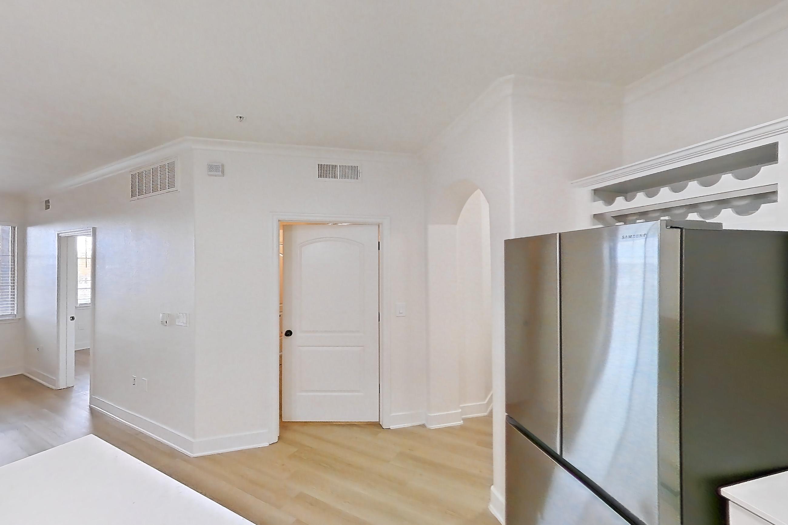 Kitchen with dishwasher, electric range, light countertops, light stone countertops, light wood-finish flooring, microwave, oven/range, refrigerator, and stainless steel appliances, Apartment 50-111 at Terracina