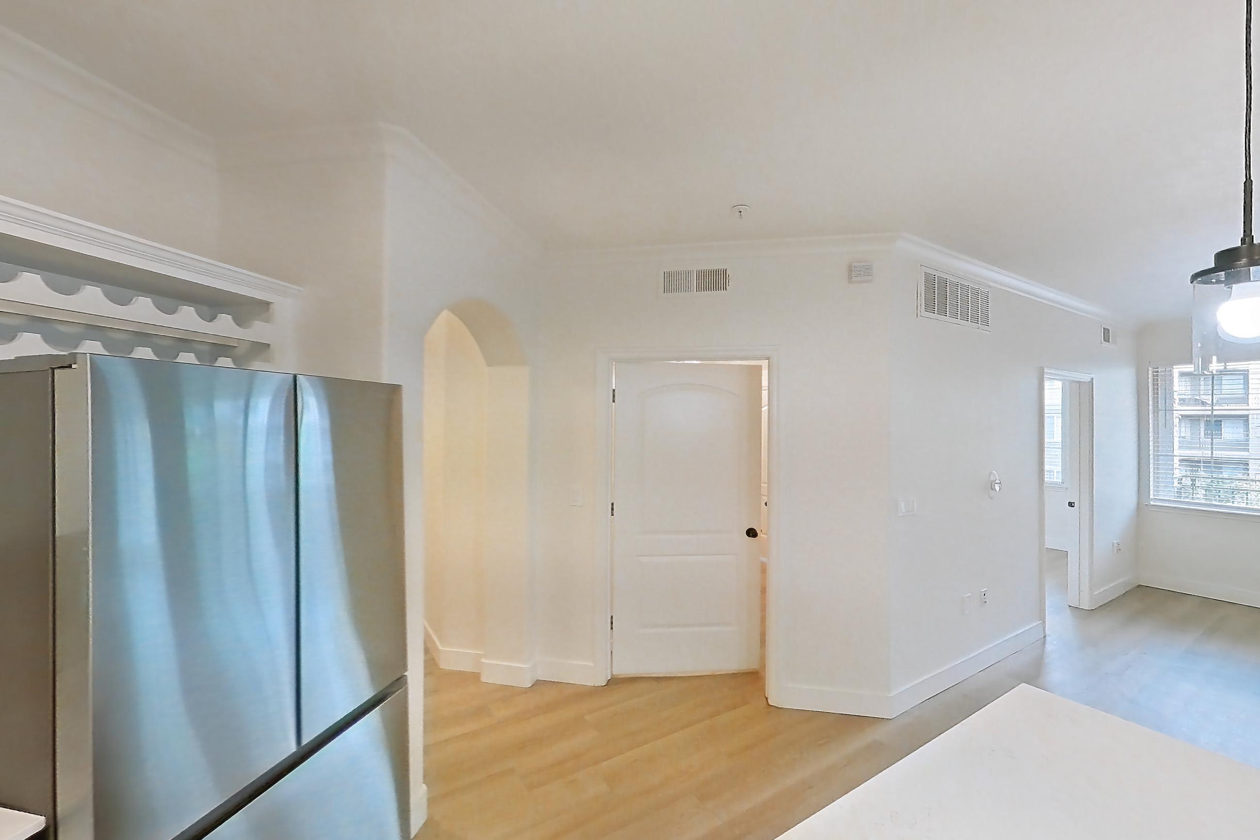 Kitchen with dishwasher, electric range, light countertops, light stone countertops, light wood-finish flooring, microwave, oven/range, refrigerator, and stainless steel appliances, Apartment 50-206 at Terracina