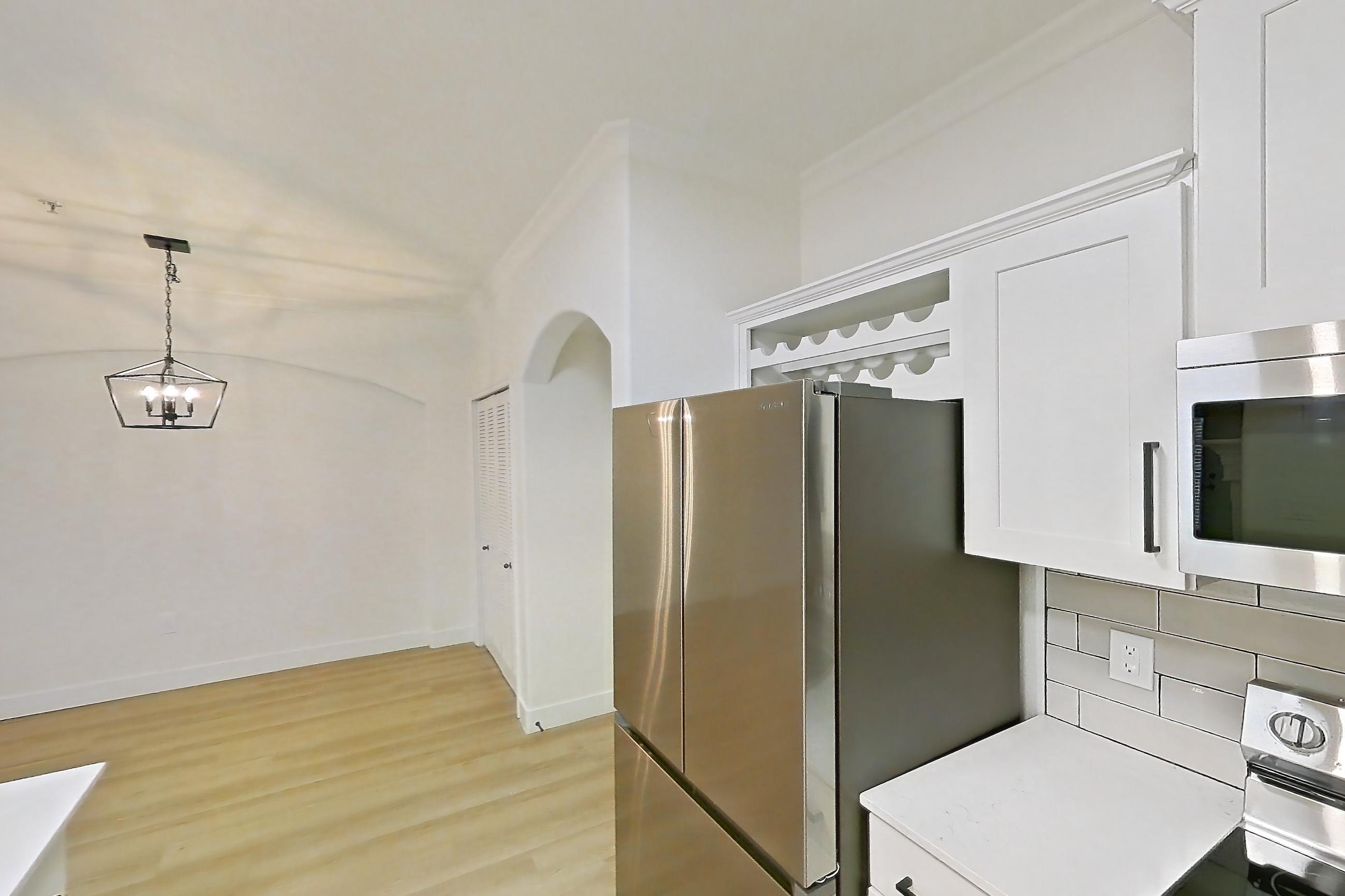 Kitchen with dishwasher, electric range, light countertops, light stone countertops, light wood-finish flooring, microwave, oven/range, refrigerator, and stainless steel appliances, Apartment 70-119 at Terracina