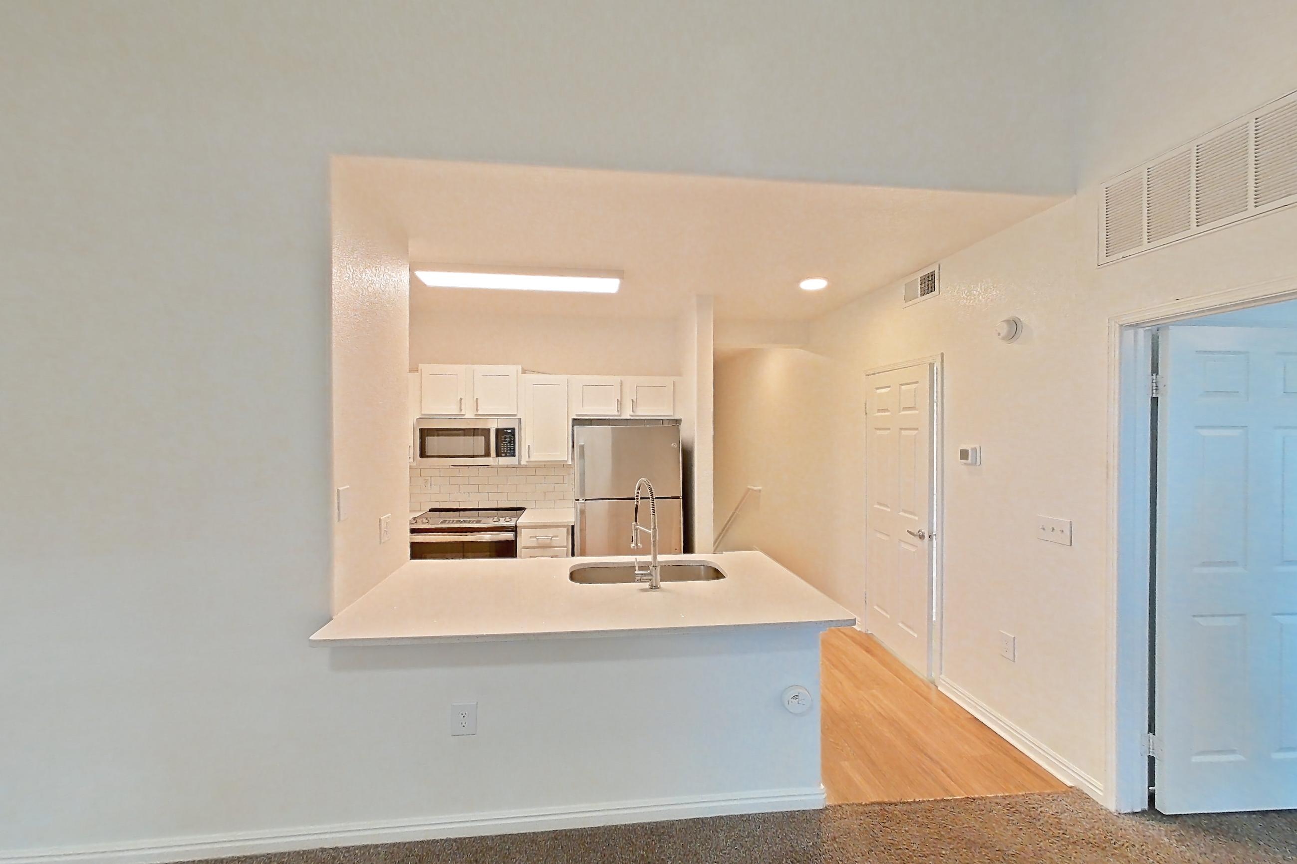Living space with oven/range, refrigerator, and stainless steel appliances, Apartment 03-203 at Eagle Ridge