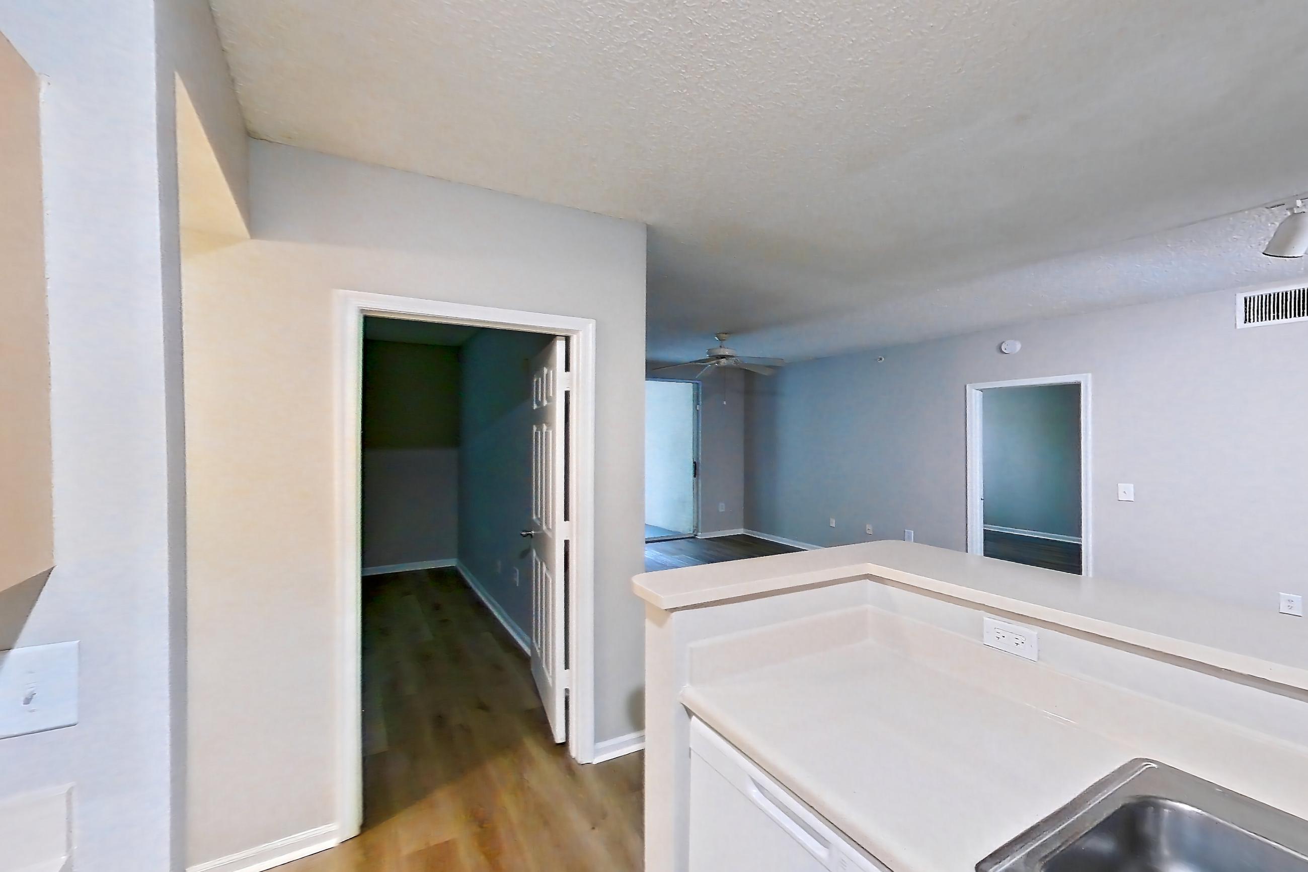 Kitchen with dishwasher, electric range, light countertops, light tile flooring, microwave, oven/range, refrigerator, and white appliances, Apartment 12-207 at Miramar Lakes