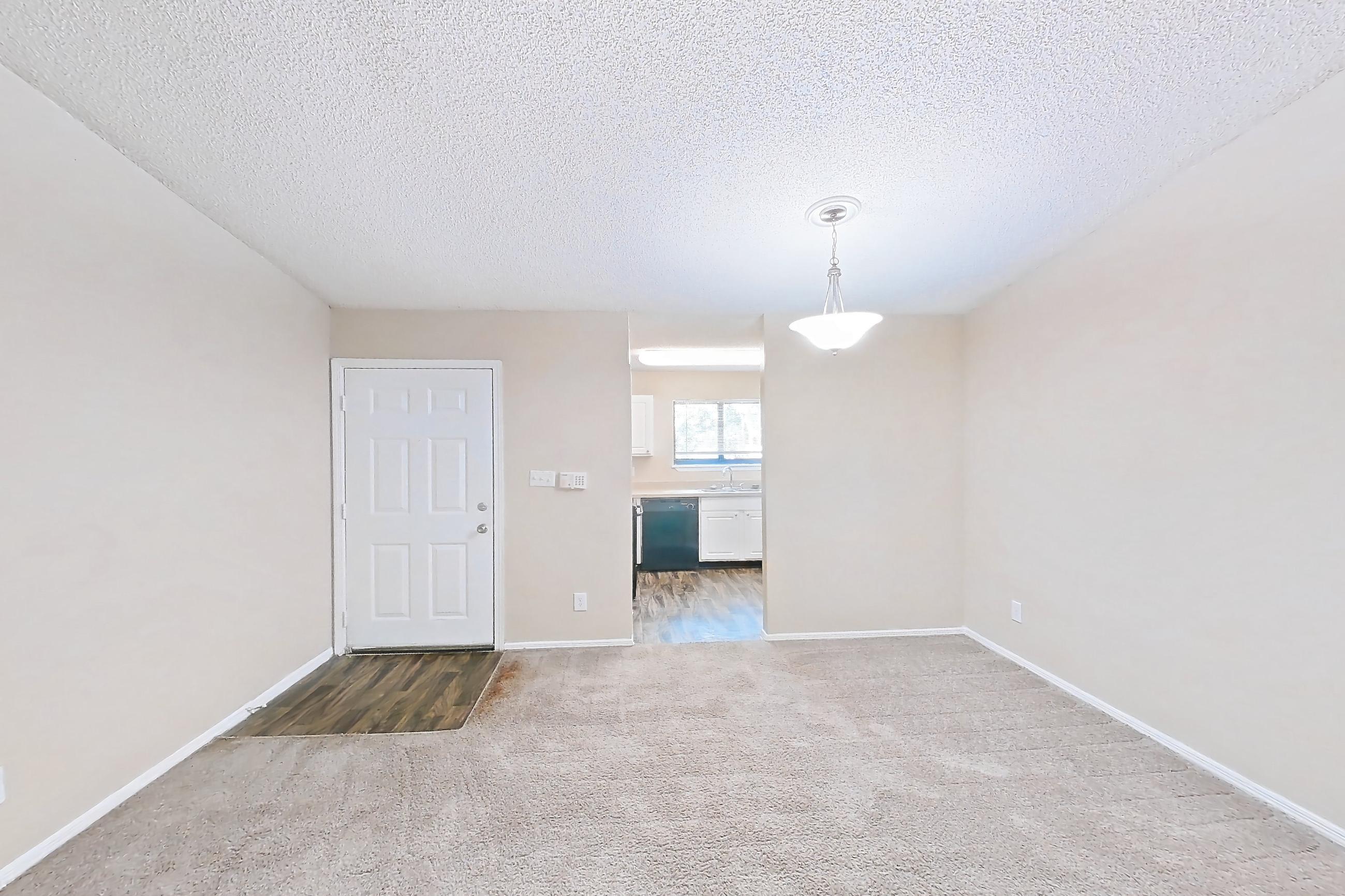 Living space with black appliances, dark carpet, and dishwasher, Apartment 0707 at The Dawson