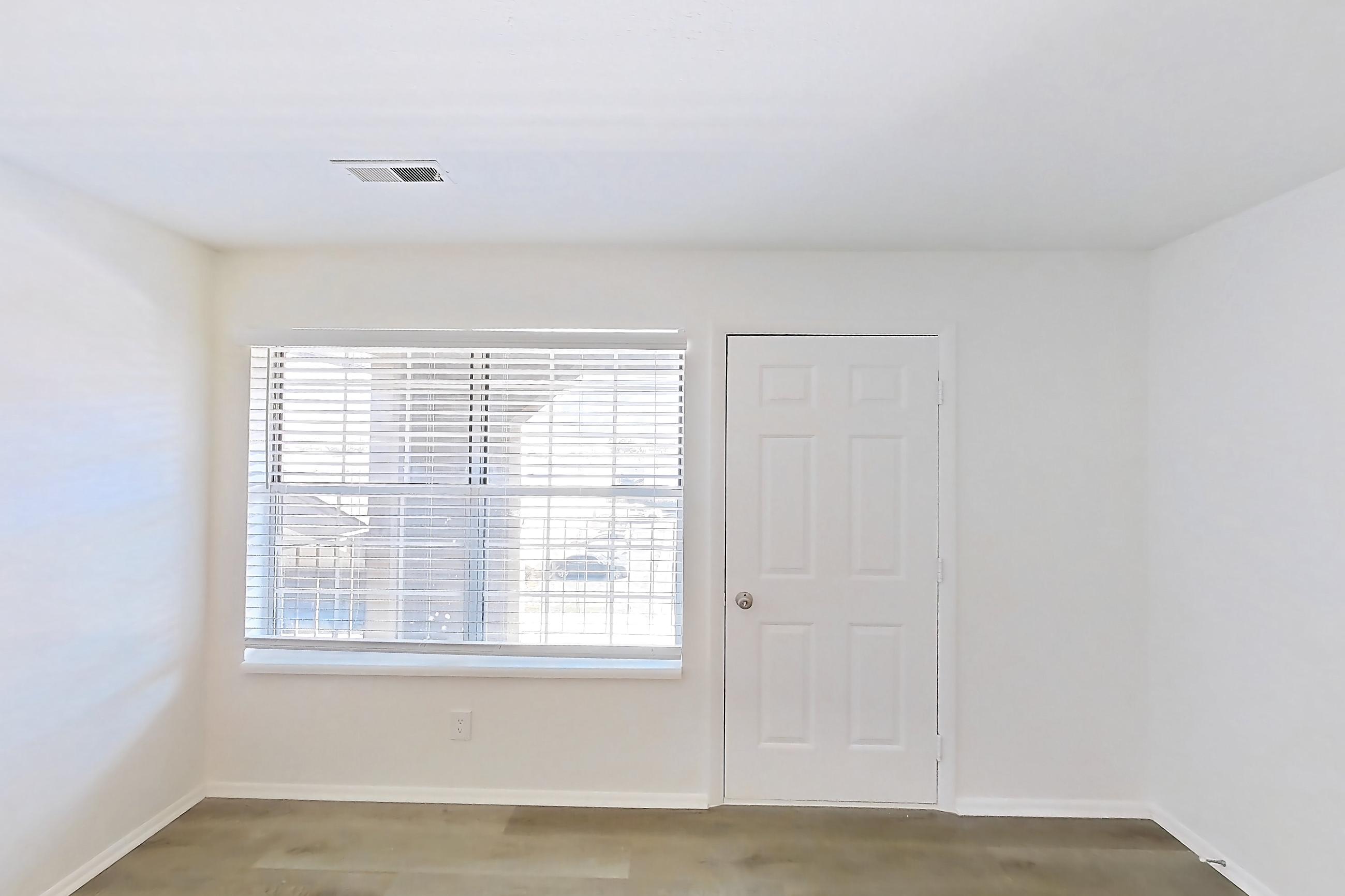 Living room with brick fireplace, fireplace, and light wood-finish flooring, Apartment 18K at Stillwater