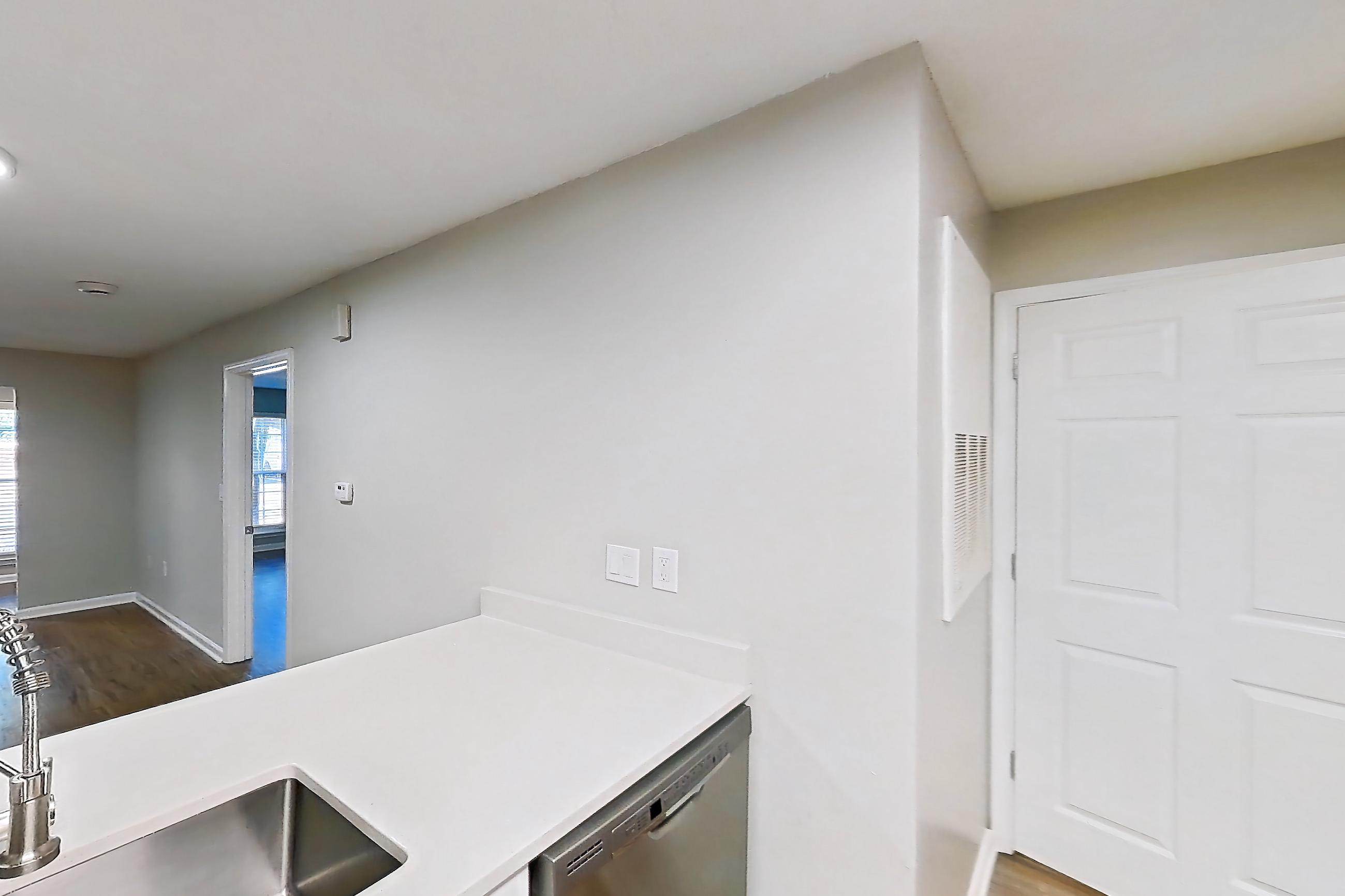 Kitchen with dishwasher, electric range, light countertops, light wood-finish flooring, microwave, oven/range, and stainless steel appliances, Apartment 6515-1C at Ashford Place