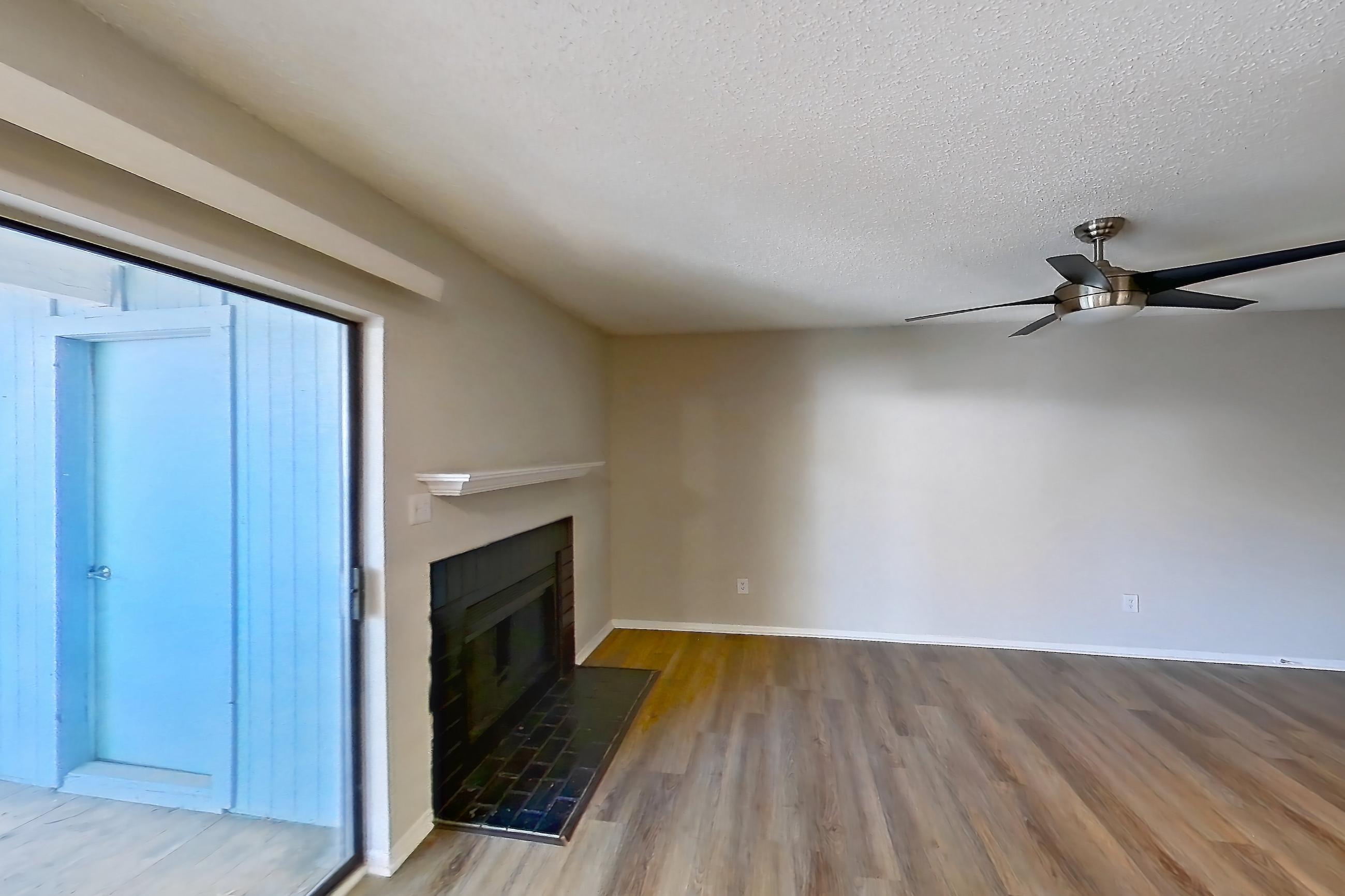 Dining room with black appliances, dishwasher, electric range, fireplace, light countertops, light wood-finish flooring, oven/range, and tile fireplace, Apartment 0616 at Beacon Hill