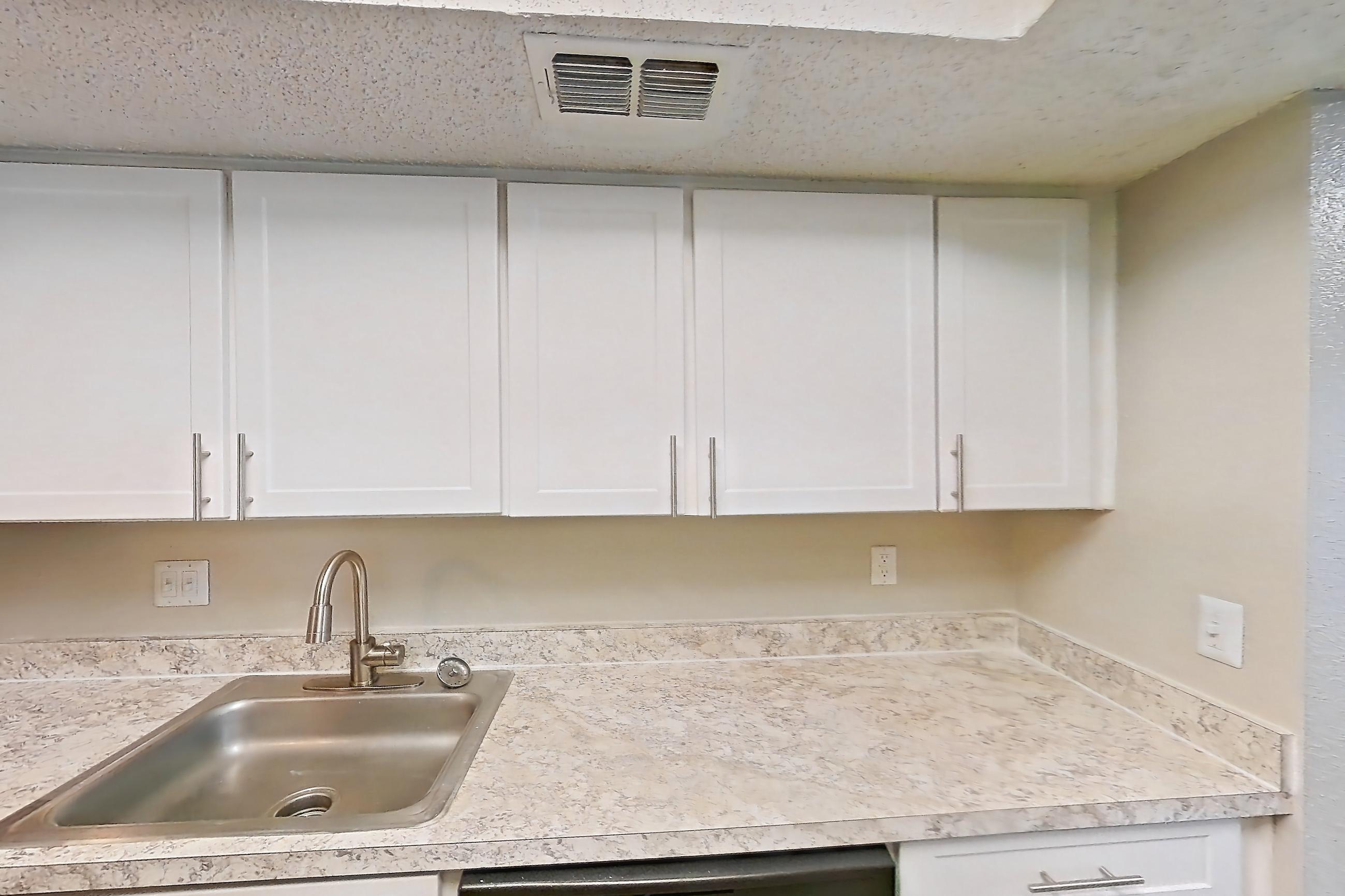 Kitchen with black appliances, dishwasher, electric range, light countertops, light wood-finish flooring, oven/range, range hood, and refrigerator, Apartment 0616 at Beacon Hill