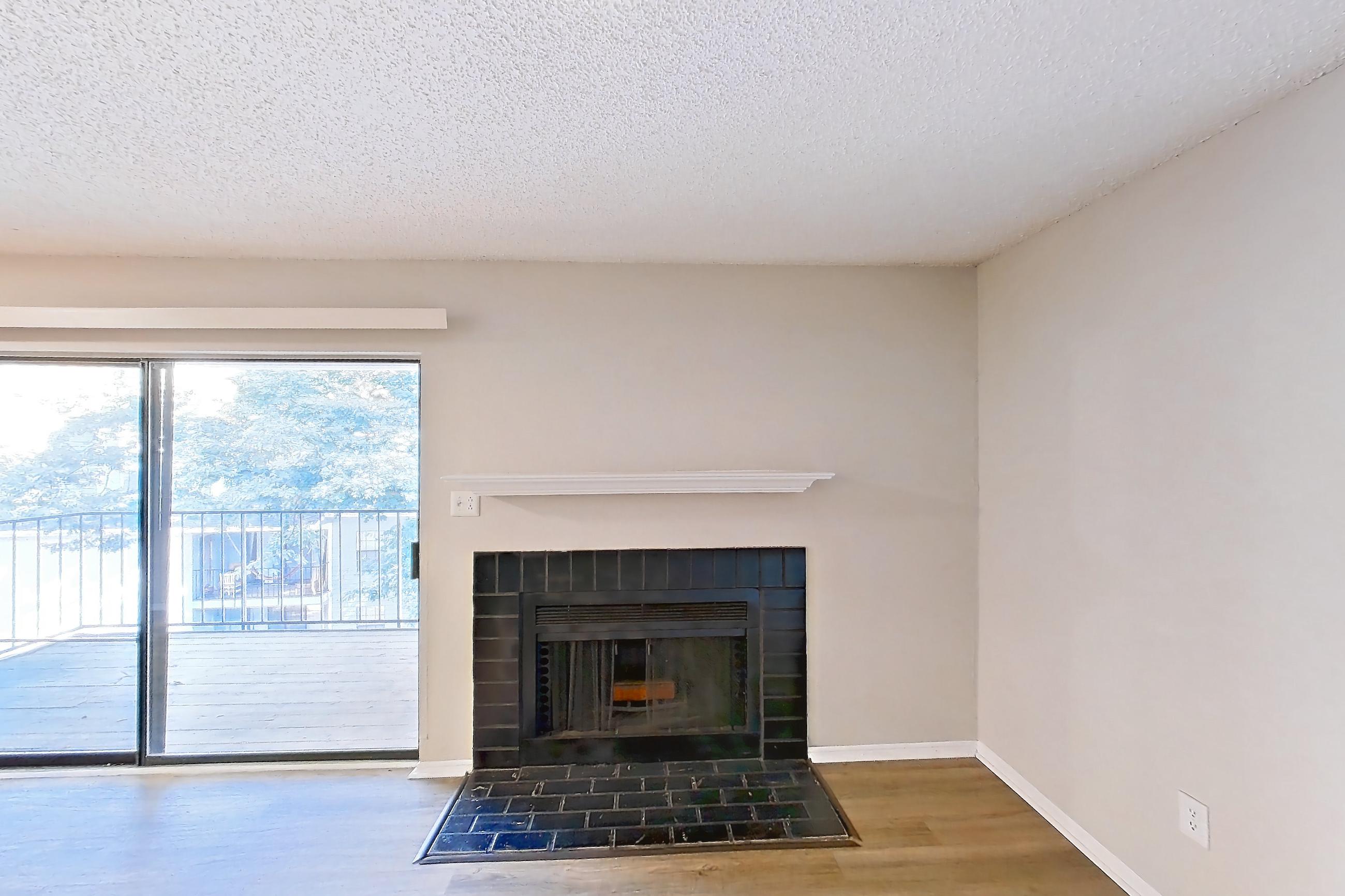 Living room with fireplace, gas range, light wood-finish flooring, oven/range, stainless steel appliances, and tile fireplace, Apartment 0616 at Beacon Hill
