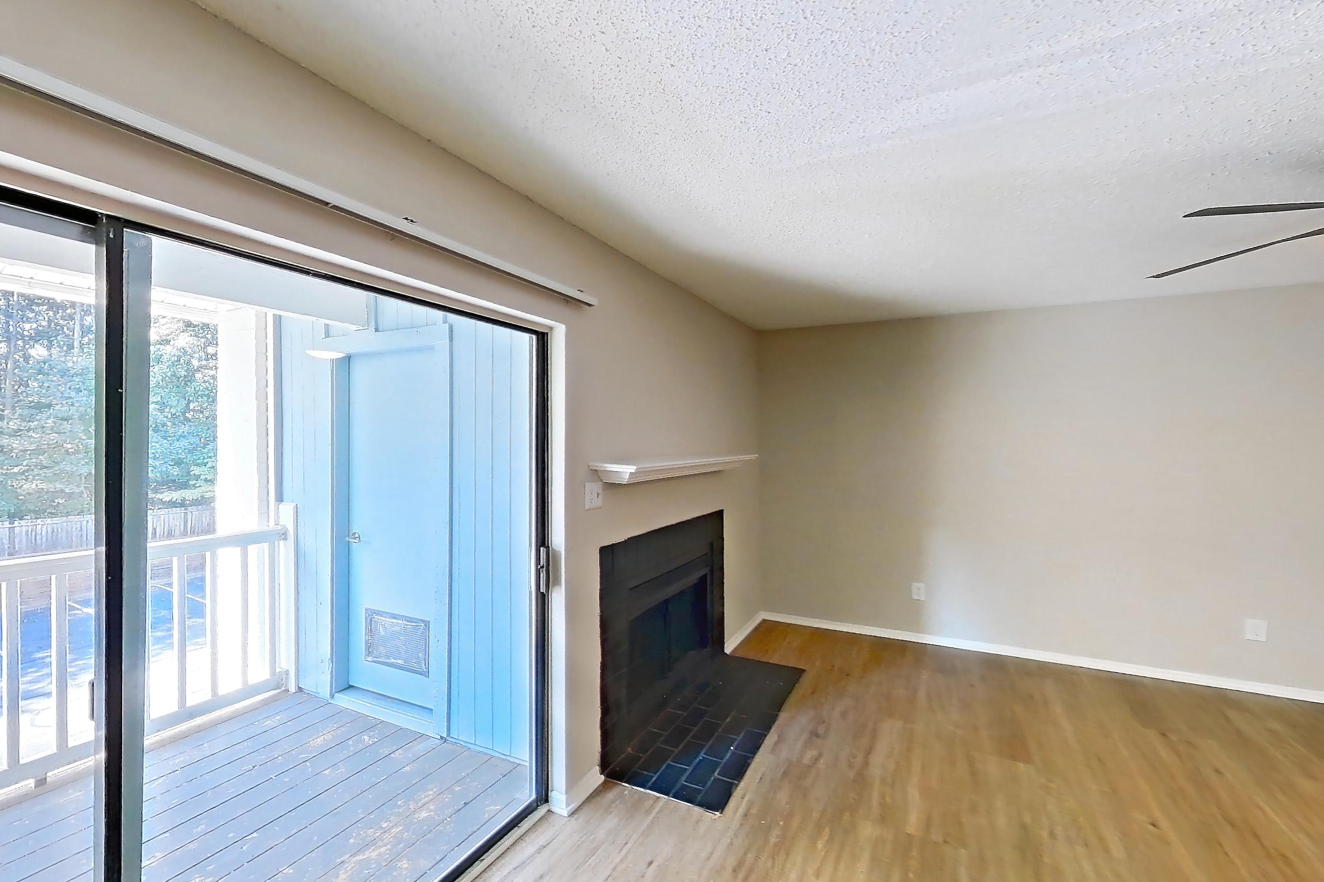 Dining room with fireplace and light wood-finish flooring, Apartment 0618 at Beacon Hill