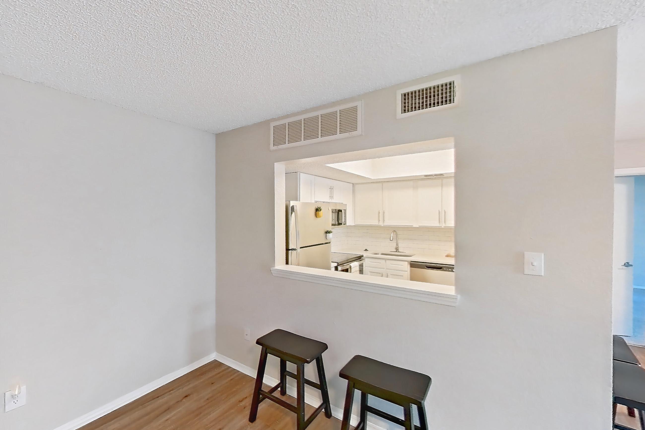 Living room with dishwasher, electric range, light wood-finish flooring, oven/range, refrigerator, stainless steel appliances, and white appliances, Apartment 1022 at Beacon Hill