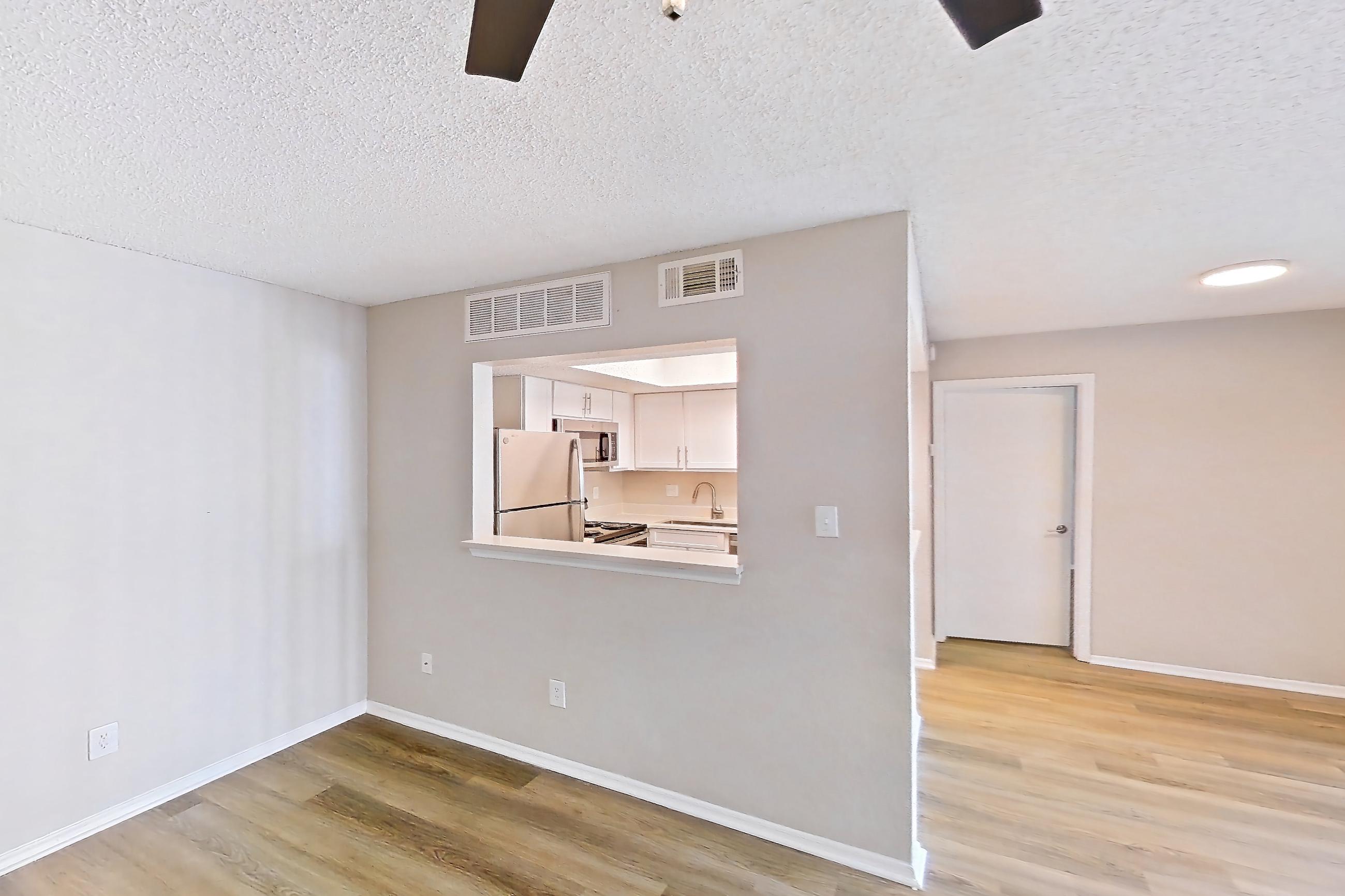 Living room with electric range, light wood-finish flooring, refrigerator, and white appliances, Apartment 0414 at Beacon Hill