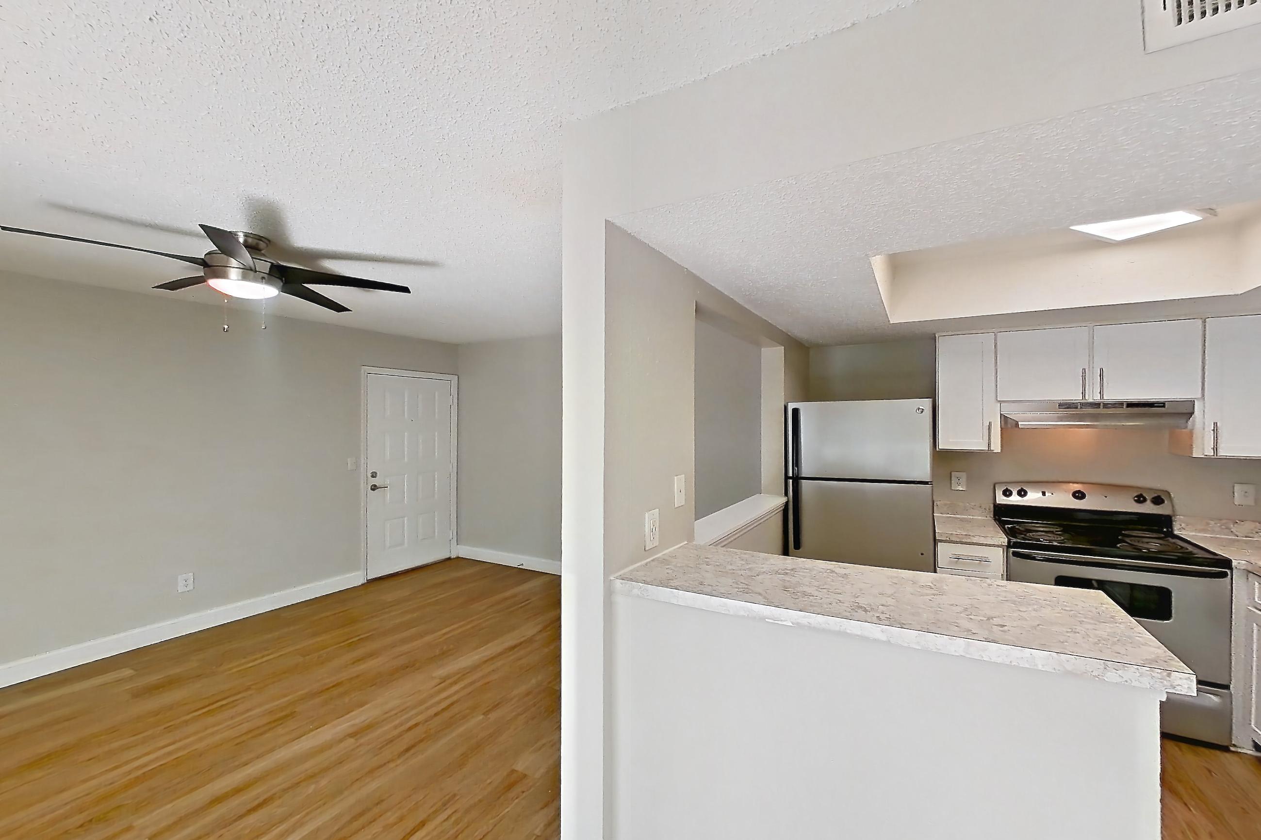 Dining room with dishwasher, light countertops, light wood-finish flooring, oven/range, and stainless steel appliances, Apartment 0610 at Beacon Hill