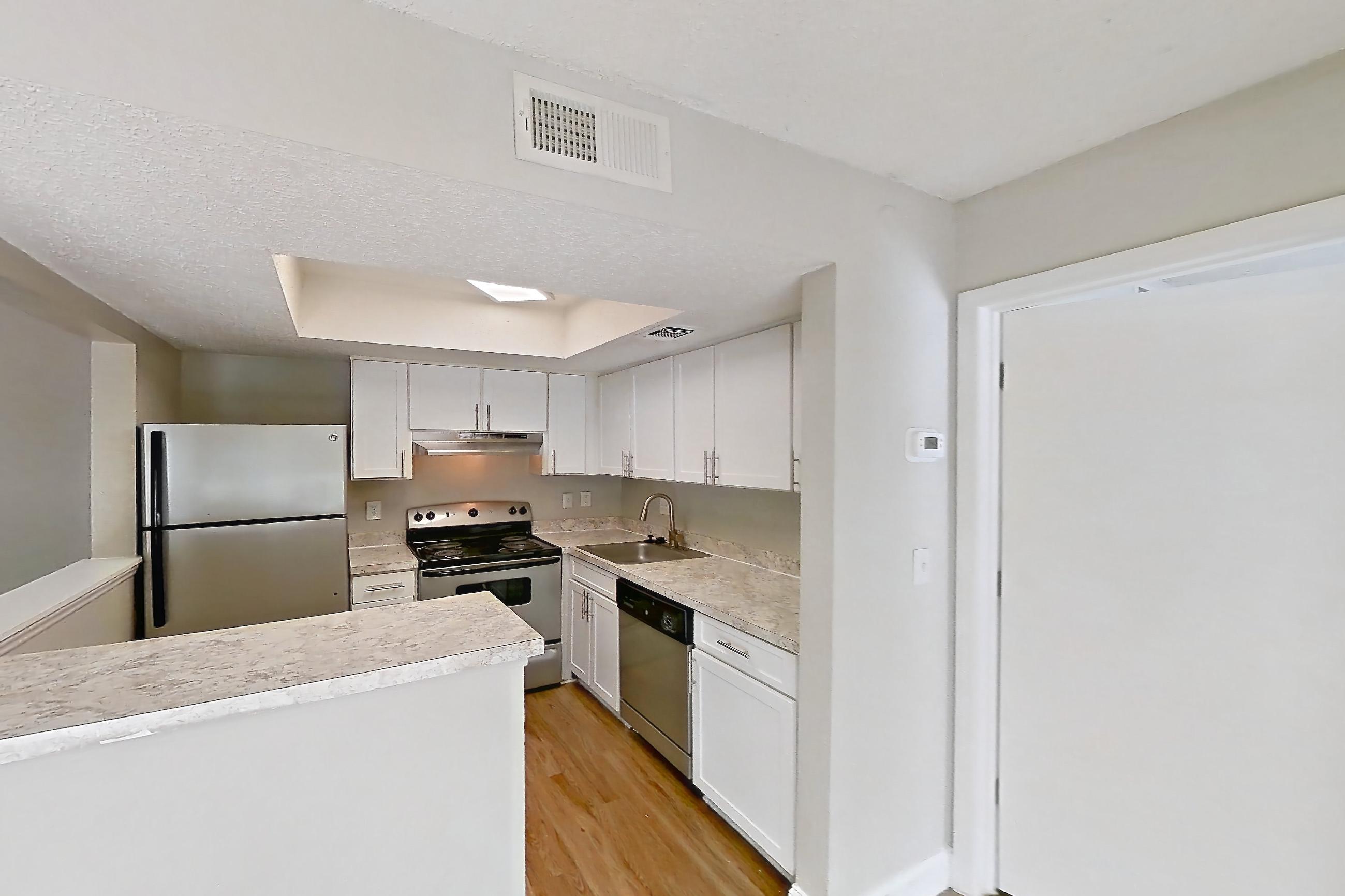 Dining room with dishwasher, light countertops, light wood-finish flooring, oven/range, and stainless steel appliances, Apartment 0610 at Beacon Hill