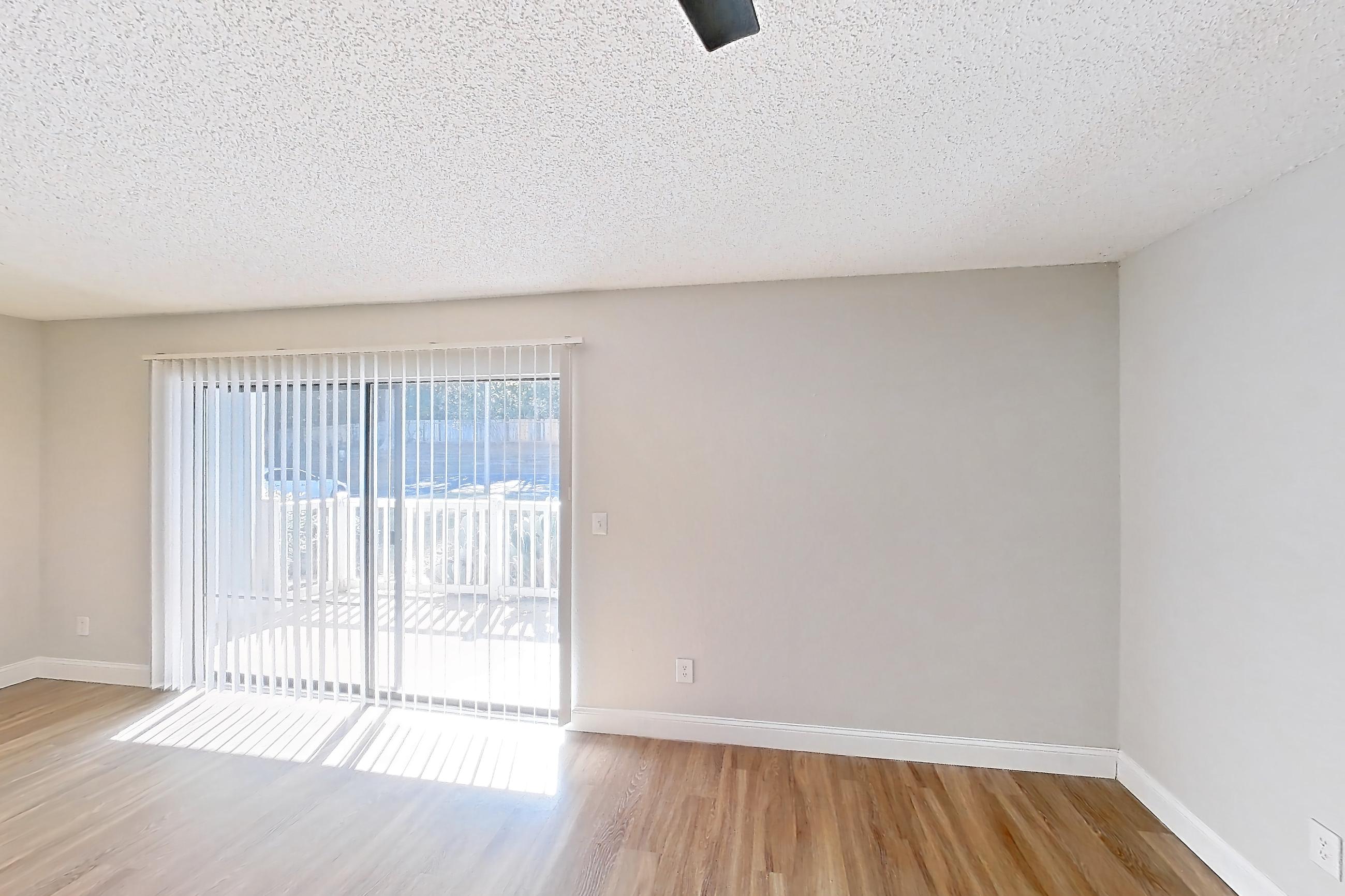 Living room with dishwasher, light wood-finish flooring, oven/range, refrigerator, stainless steel appliances, and white appliances, Apartment 0610 at Beacon Hill