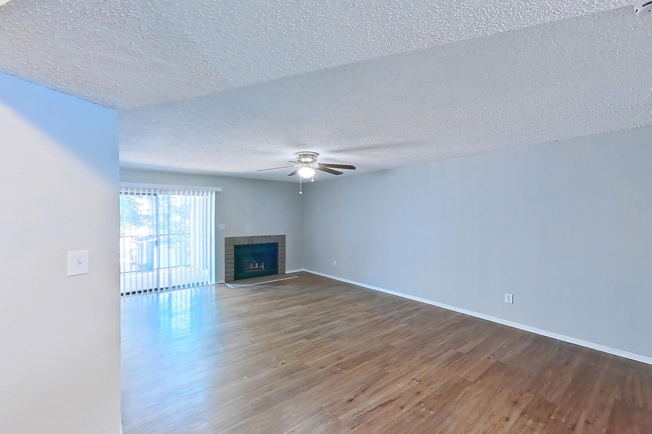 Dining room with brick fireplace, dark wood-finish flooring, electric range, fireplace, light countertops, oven/range, and white appliances, Apartment 0841 at Beacon Hill