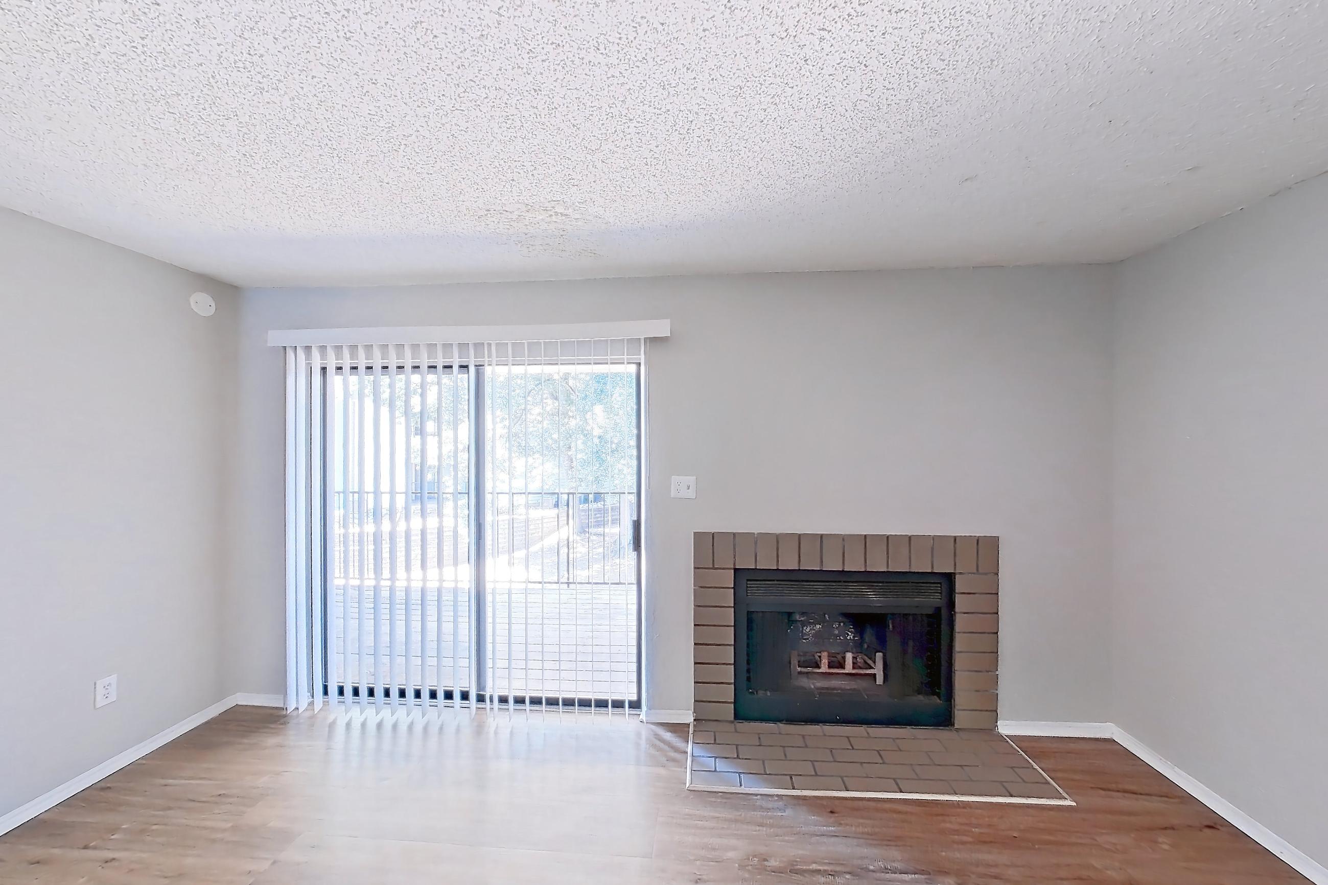 Living room with brick fireplace, fireplace, and light wood-finish flooring, Apartment 0841 at Beacon Hill