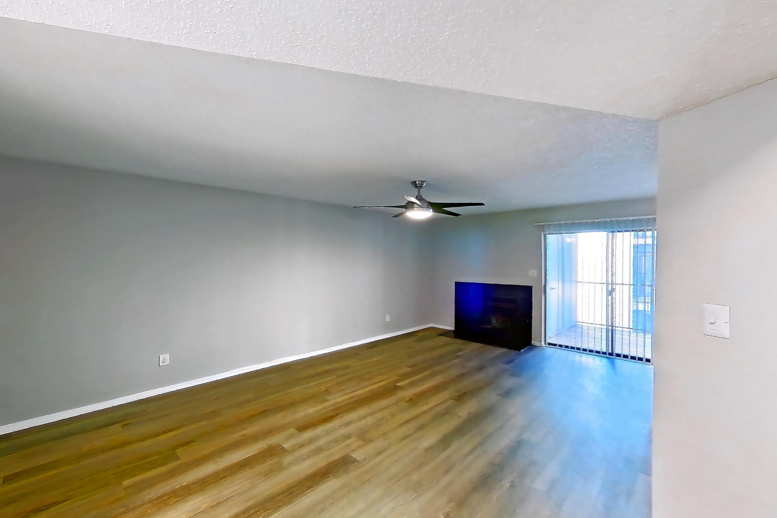 Dining room with black appliances, electric range, fireplace, light countertops, light wood-finish flooring, and oven/range, Apartment 0505 at Beacon Hill