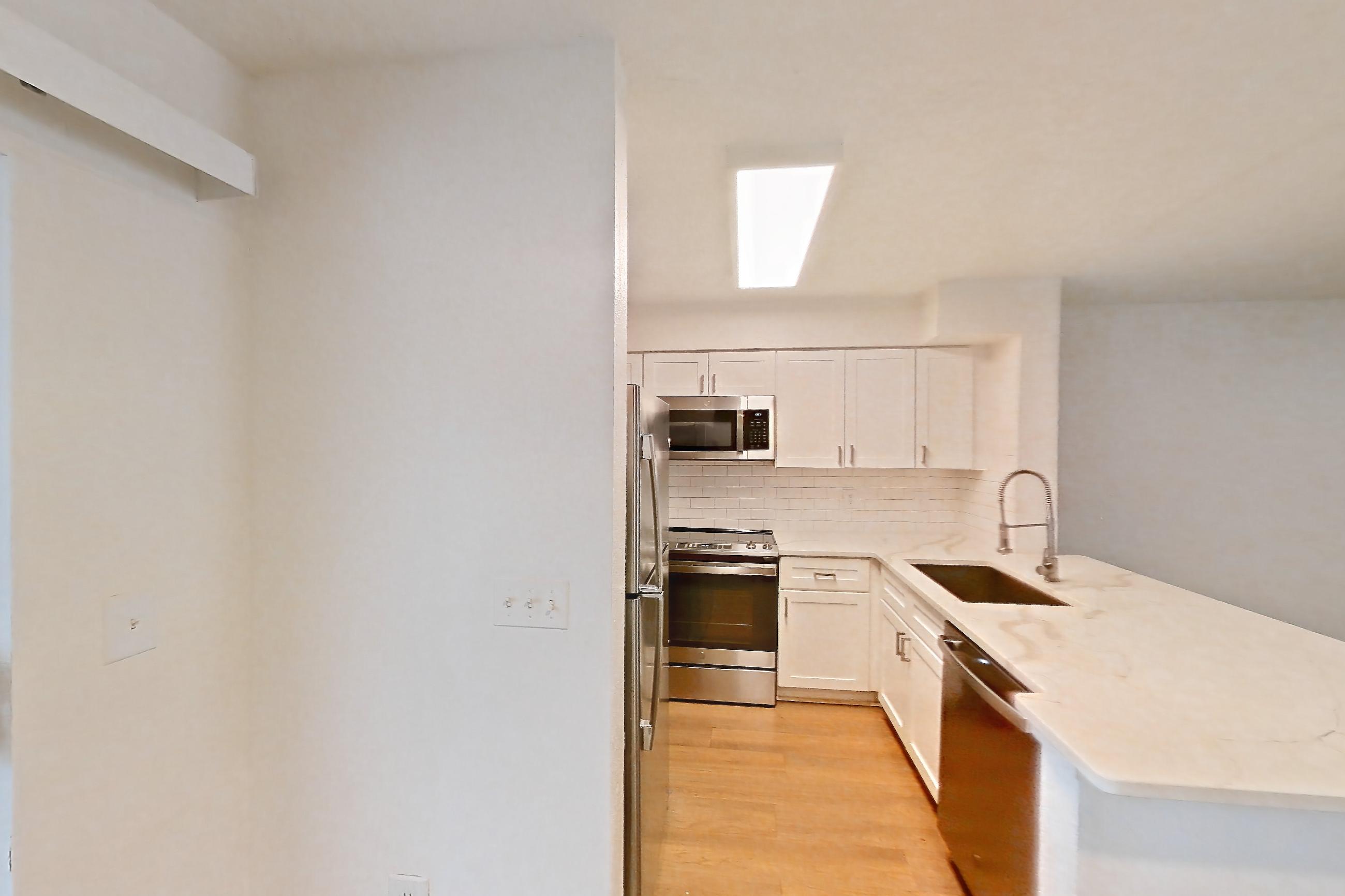 Dining room with dishwasher, electric range, light stone countertops, light wood-finish flooring, oven/range, refrigerator, and stainless steel appliances, Apartment 10-1203 at Brookwood Club