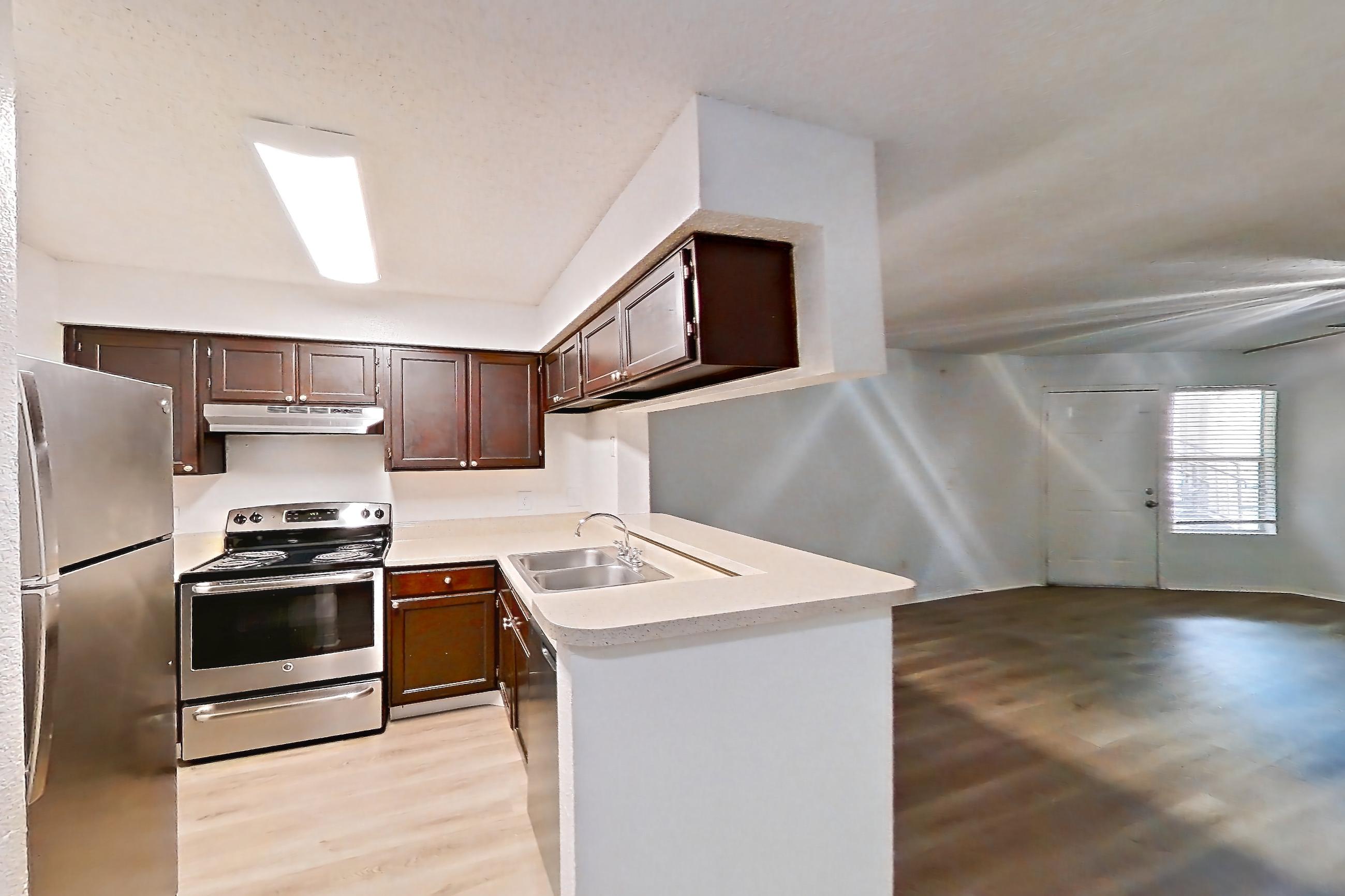 Dining room with light countertops and light wood-finish flooring, Apartment 10-1102 at Brookwood Club