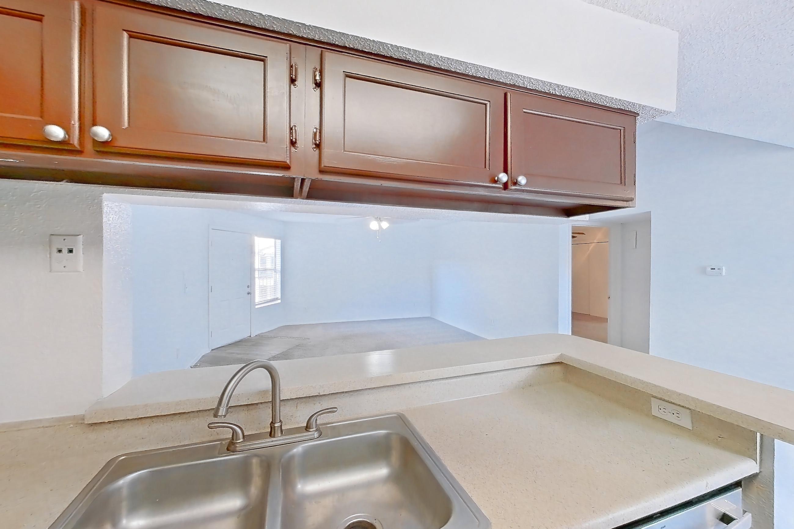 Kitchen with dishwasher, electric range, light countertops, light wood-finish flooring, microwave, oven/range, refrigerator, stainless steel appliances, and white appliances, Apartment 20-0817 at Brookwood Club