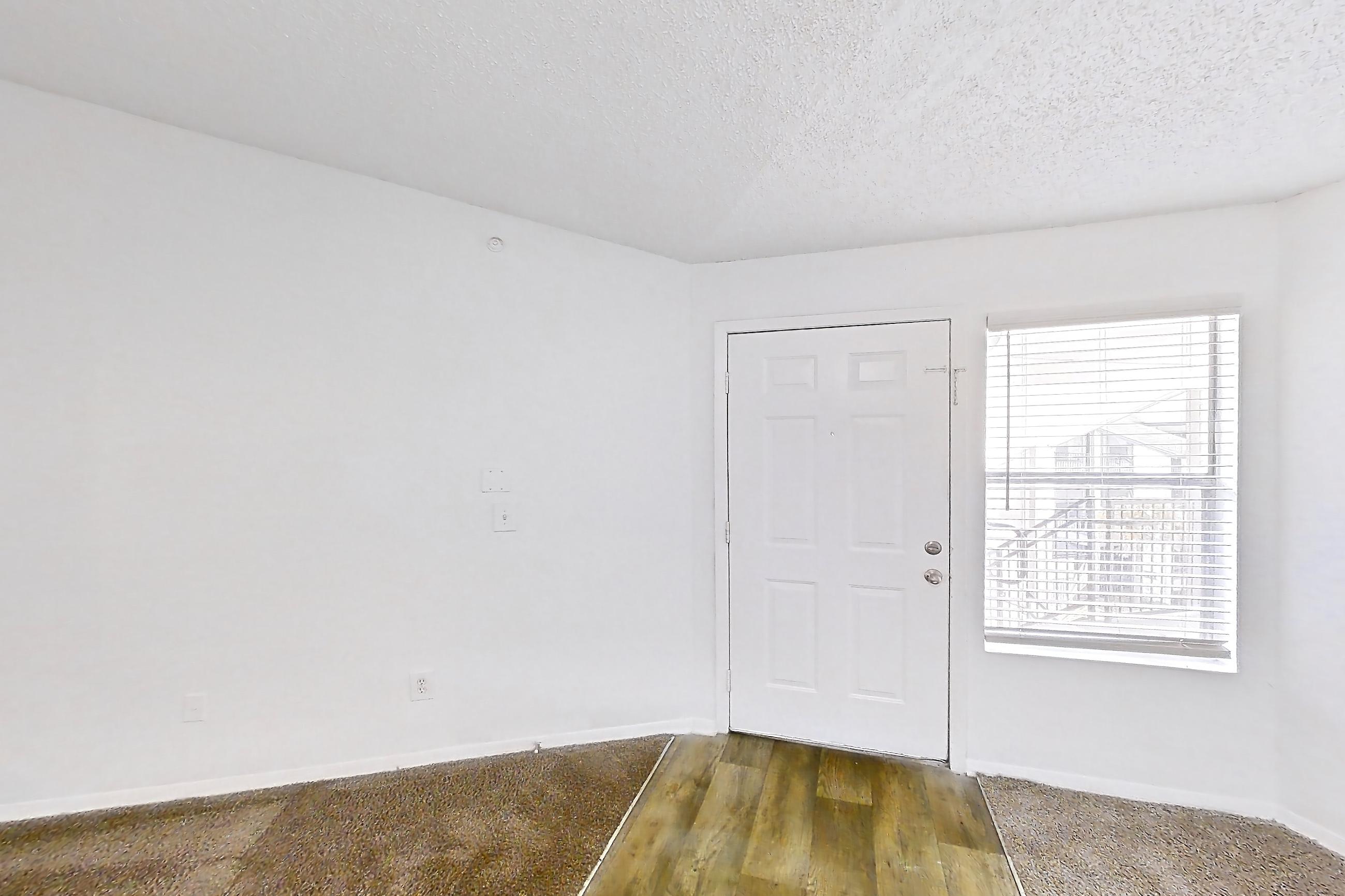 Living room with refrigerator and stainless steel appliances, Apartment 20-0817 at Brookwood Club