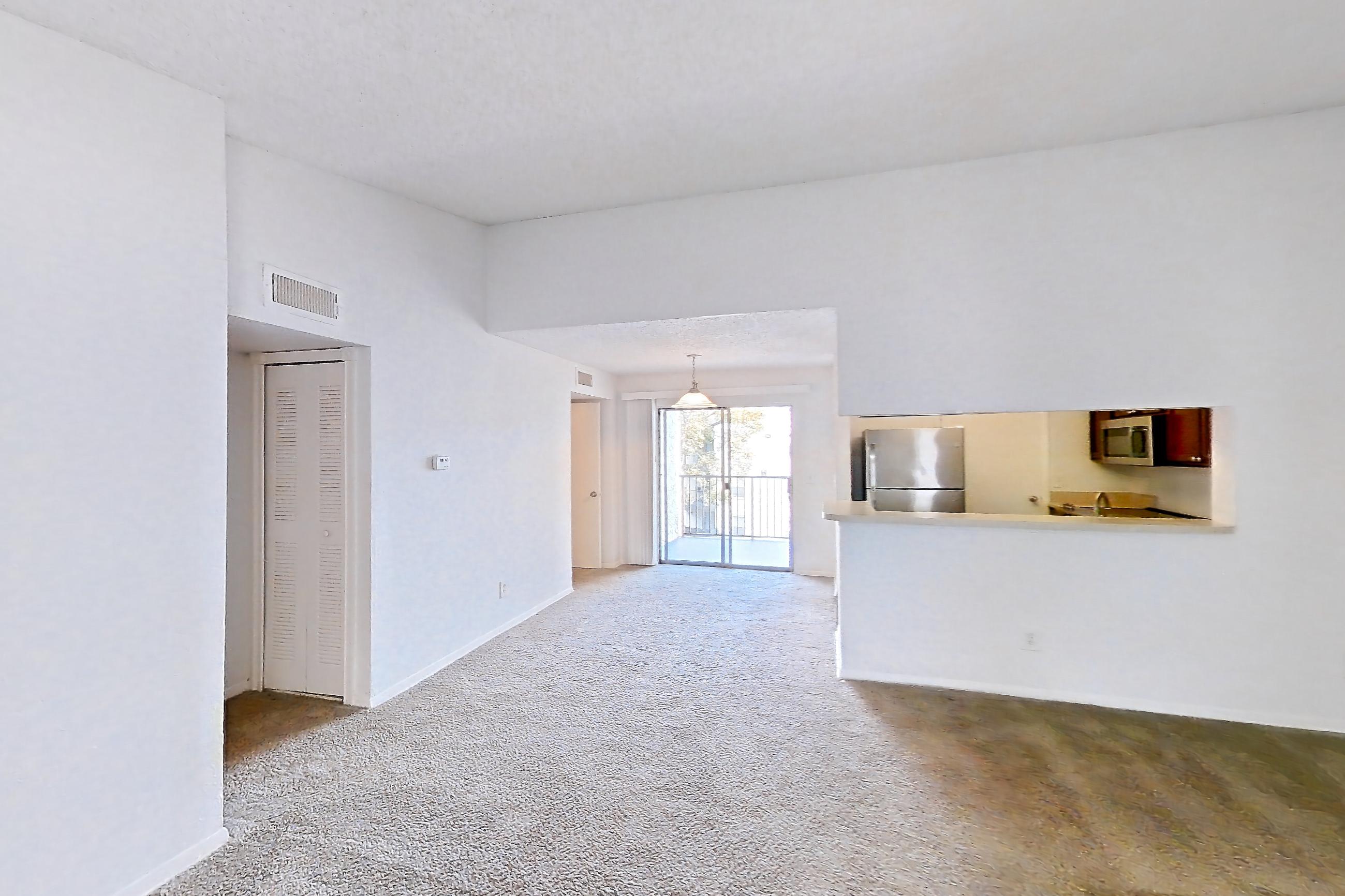 Living room with refrigerator and stainless steel appliances, Apartment 20-0817 at Brookwood Club