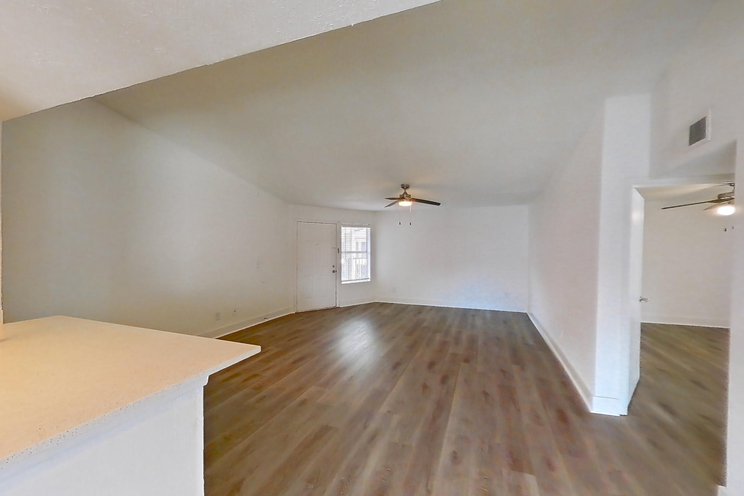 Dining room with electric range, light countertops, light stone countertops, light wood-finish flooring, oven/range, refrigerator, and stainless steel appliances, Apartment 20-0517 at Brookwood Club