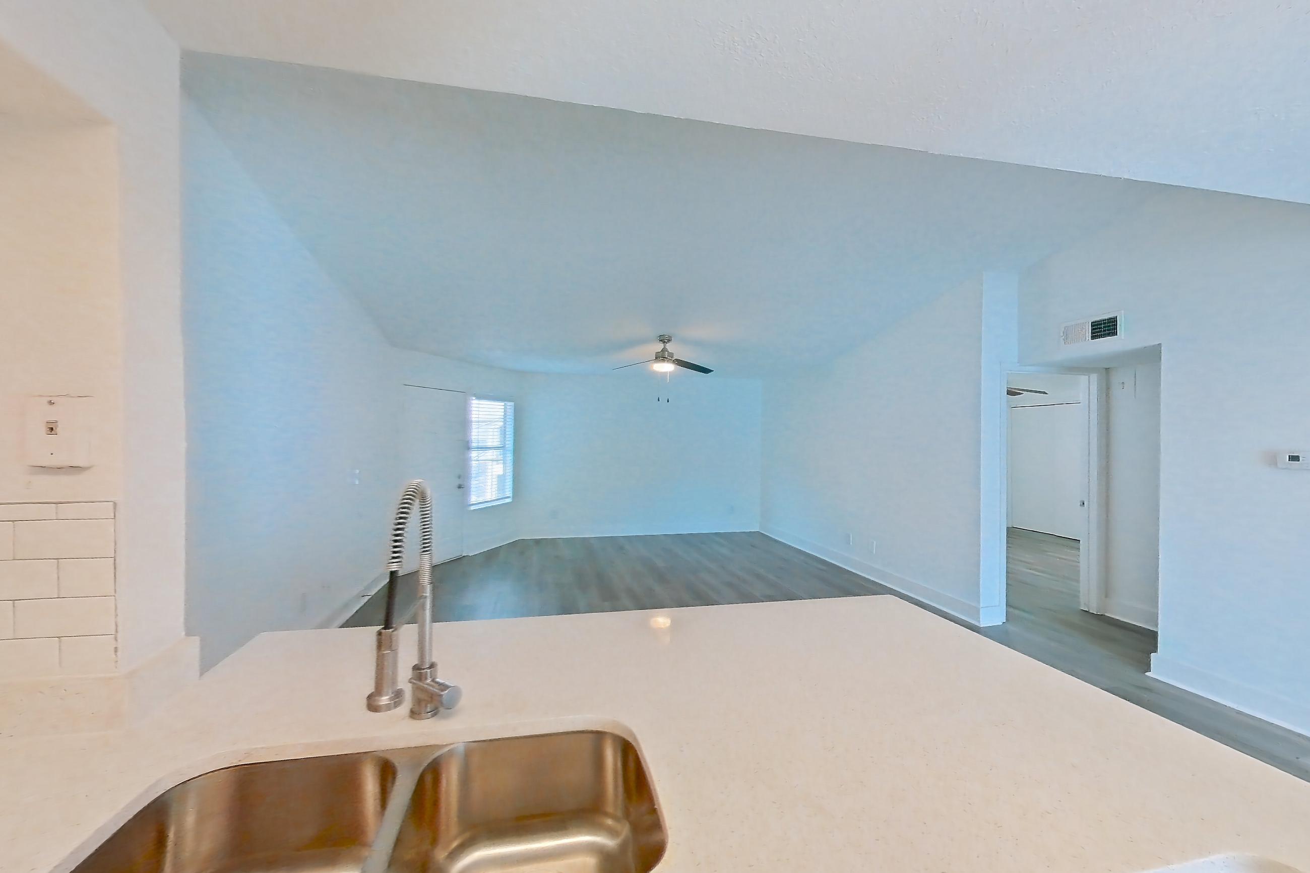 Kitchen with dishwasher, electric range, light countertops, light stone countertops, light wood-finish flooring, microwave, oven/range, refrigerator, and stainless steel appliances, Apartment 20-0517 at Brookwood Club