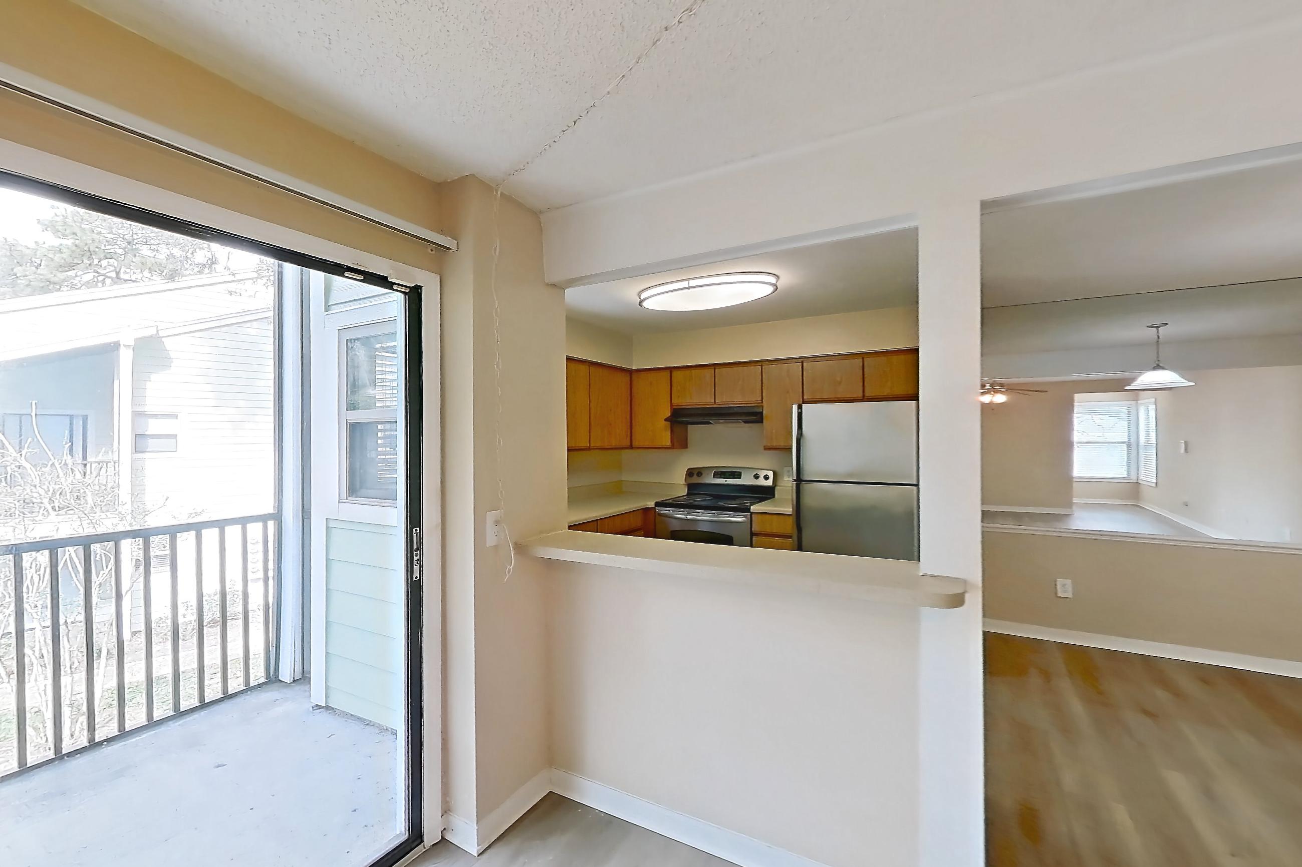 Living space with electric range, light countertops, light wood-finish flooring, oven/range, refrigerator, and stainless steel appliances, Apartment 4038SL at Oak Ramble