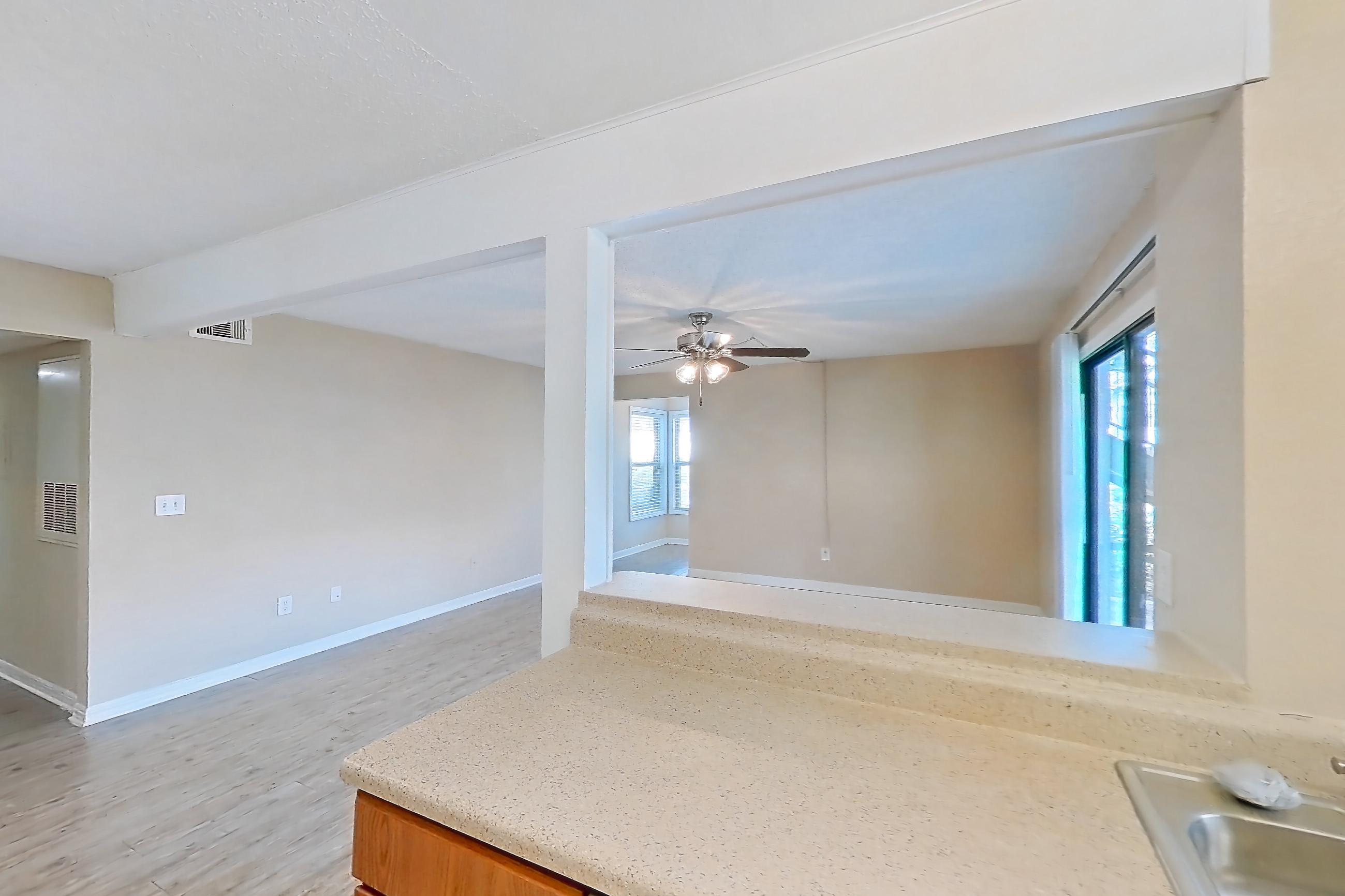 Kitchen with dishwasher, electric range, light countertops, light wood-finish flooring, oven/range, range hood, refrigerator, and stainless steel appliances, Apartment 5021MB at Oak Ramble